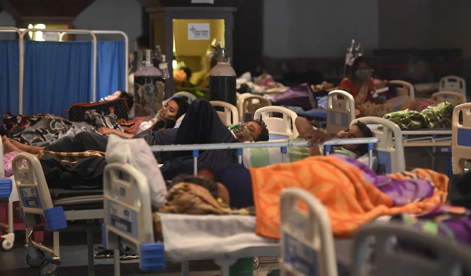 COVID-19 patients are treated in a makeshift ward in India.