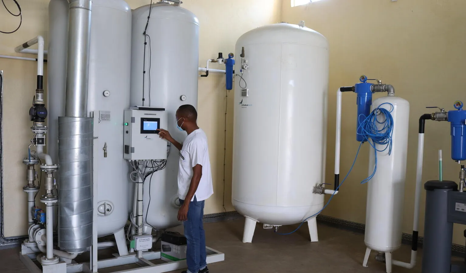 A technician checks an oxygen plant in Uganda.