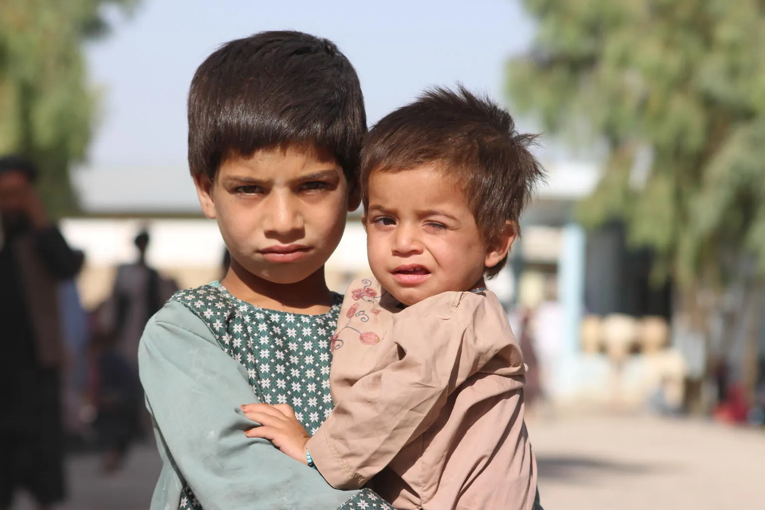 From left: Mohammad Dawood, 5 years old and his brother Sayed Ahmad, 2 years old, have been moved from Maiwand District to Haji IDP camp due to conflict and war. His father owns a shop, and he has five siblings in his family of seven. 