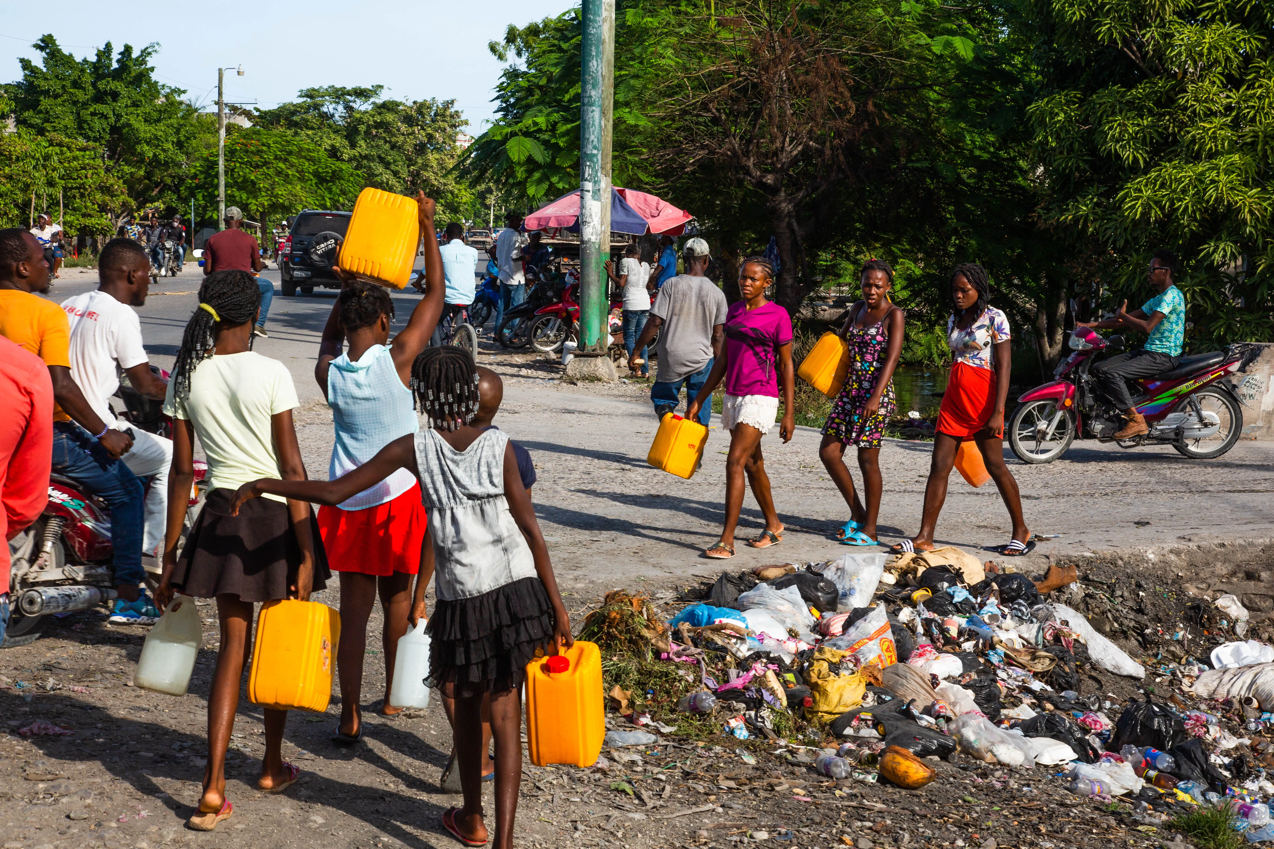 Young adults look for clean water in the city of Les Cayes, Haiti on 15 August 2021, following the 7.2 magnitude earthquake that struck on 14 August 2021.