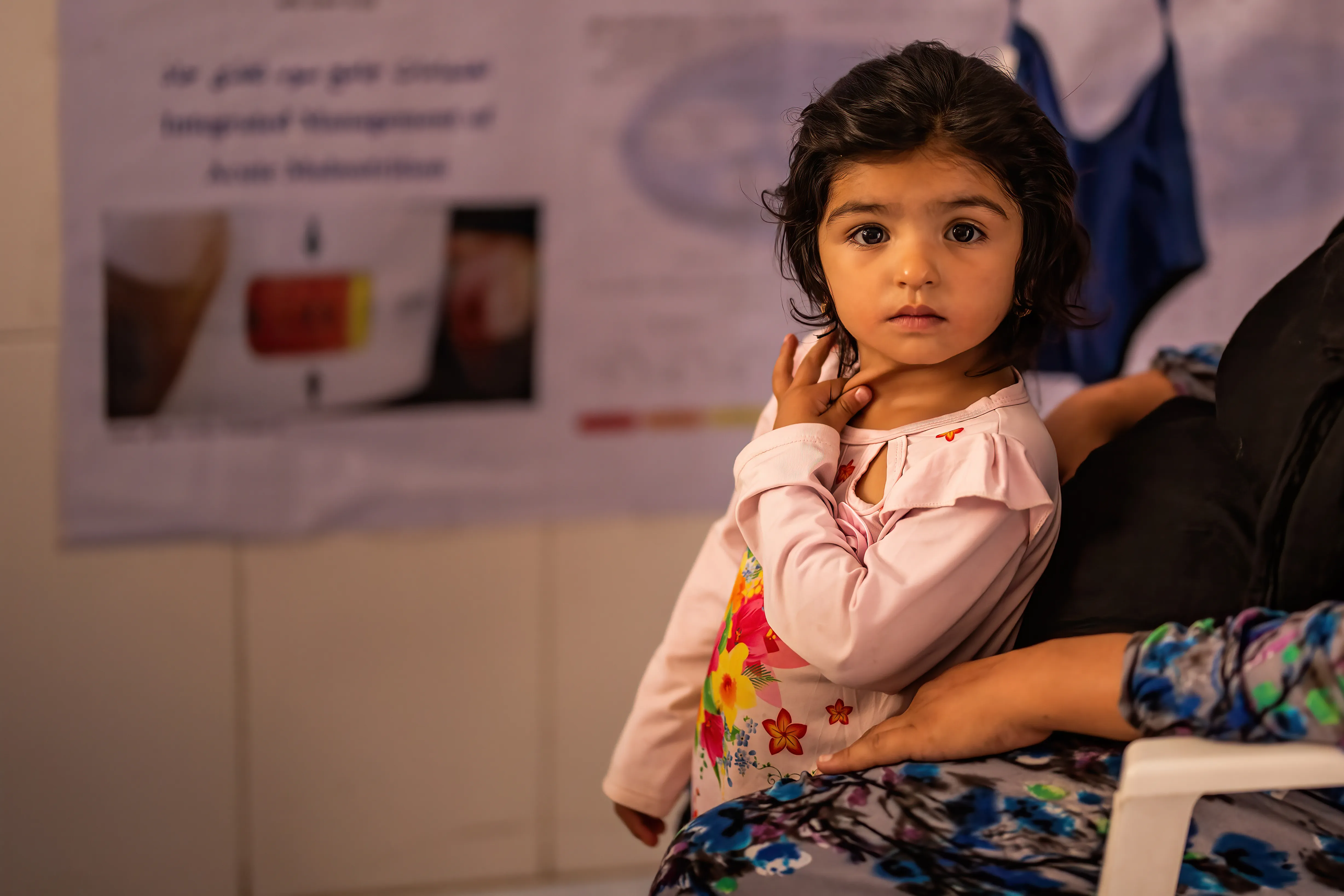 two-year-old Fatima, waits her turn for health and nutrition screening at Bab-e-Bargh health centre where UNICEF-supported immunization, health, nutrition and ante/post-natal care continue to be provided in Herat city’s largest health clinic.