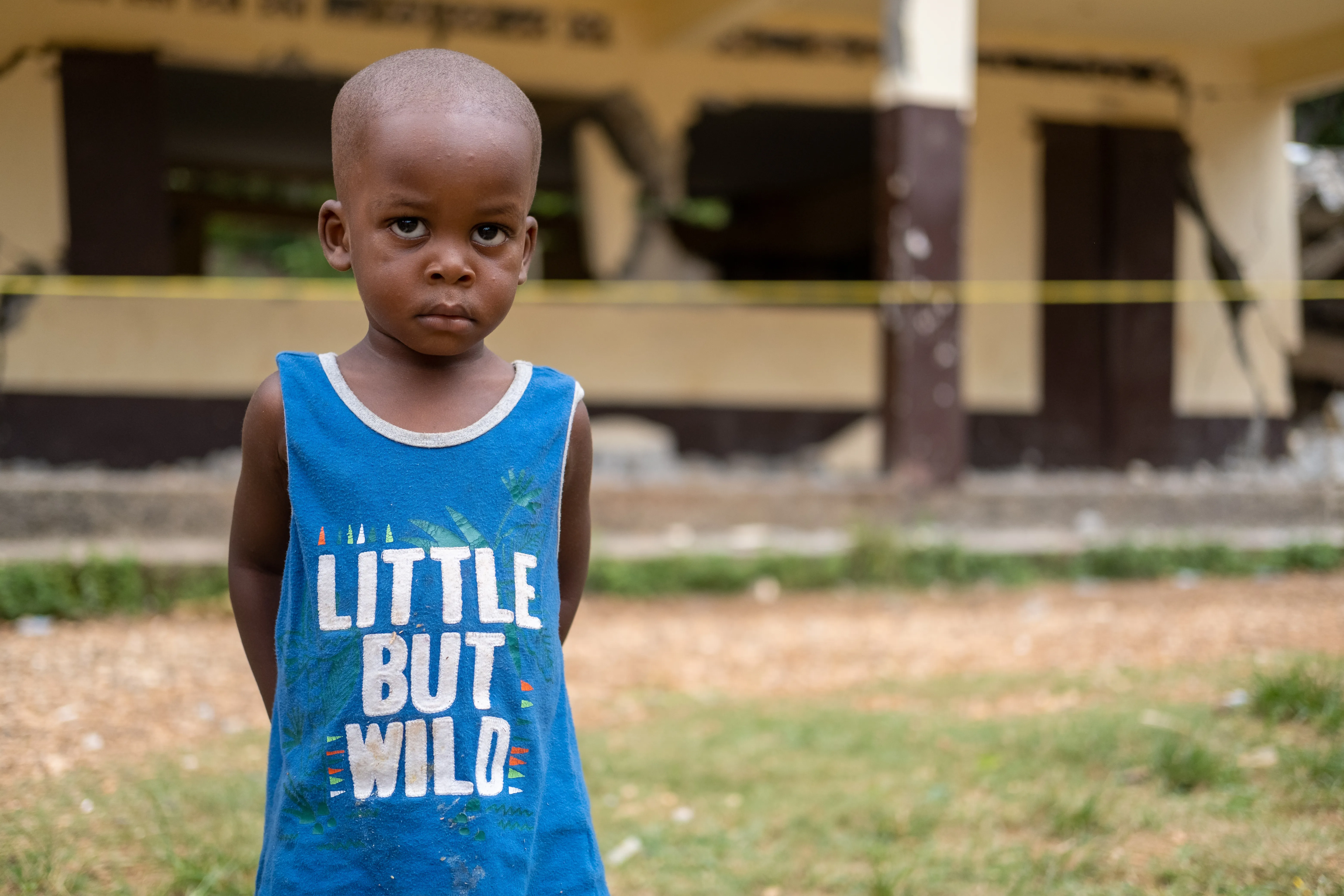 A young child stands in front of his school destroyed during the 2021 earthquake in Haiti.Notre Dame du Perpétuel Secours de Latibolière School destroyed following the earthquake that affected the South of Haiti on 14th August 2021.