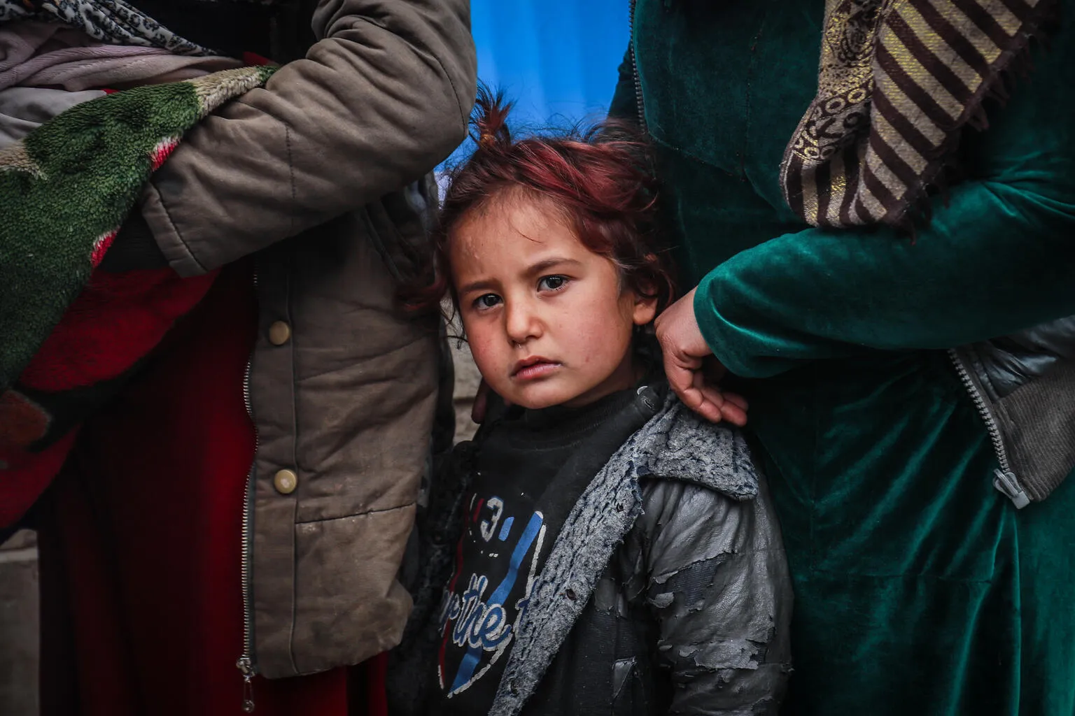 Children and families queue in front of a UNICEF mobile clinic in northeast Syria. 