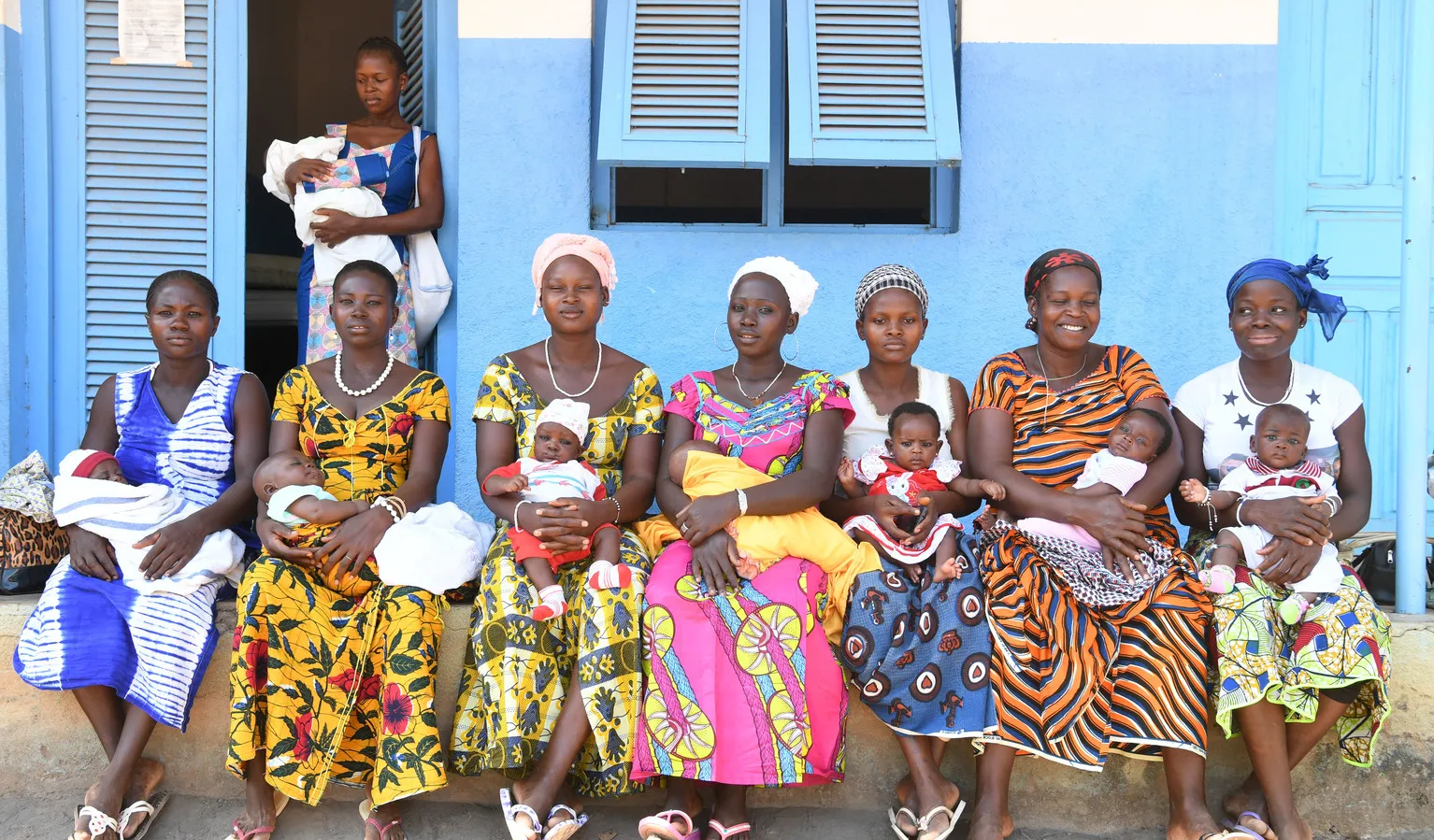women in front of a clinic in Cote d'Ivoire