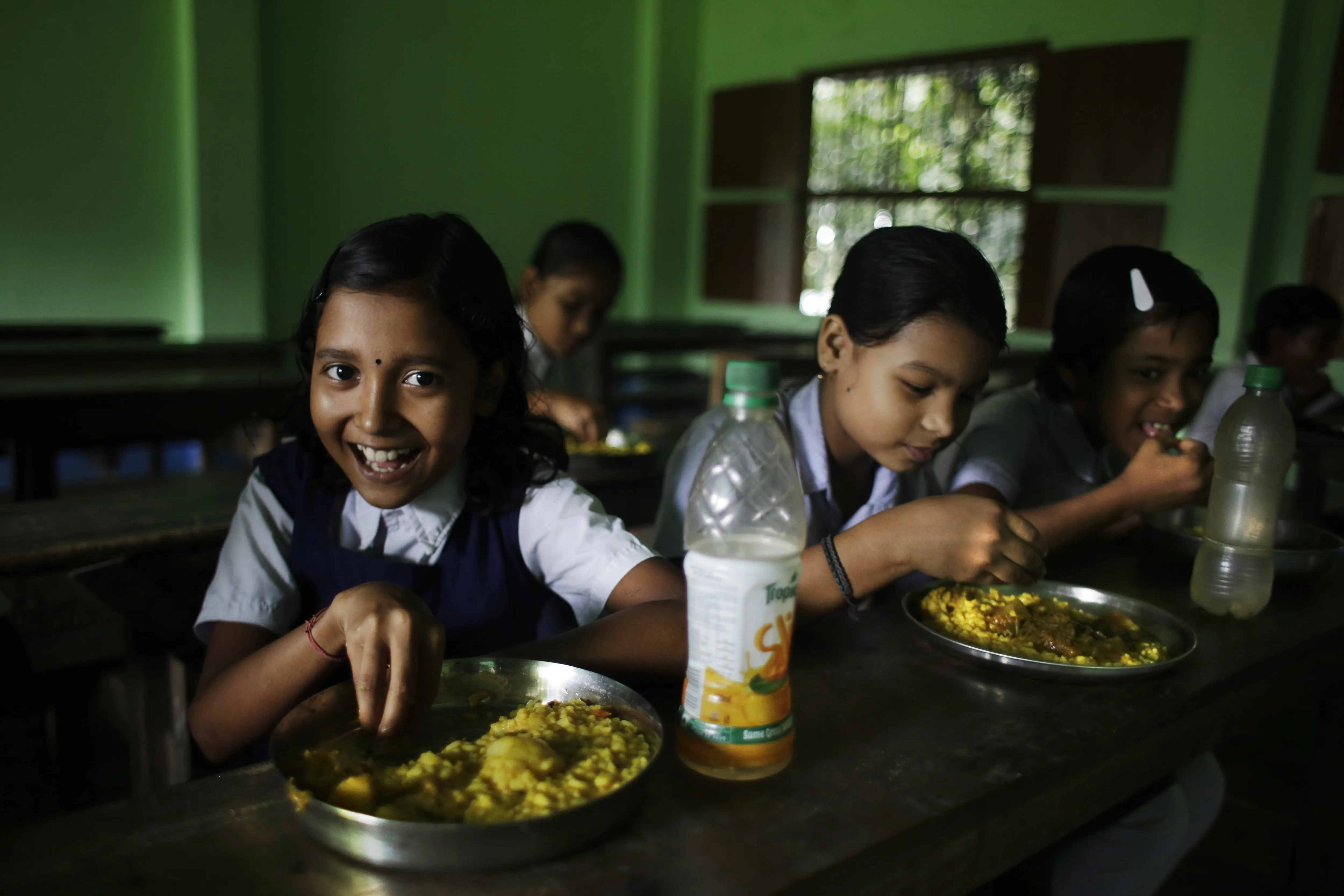 School children eat mid day meals at Mondalpara High School, Mondalpara Gaighata, West Bengal