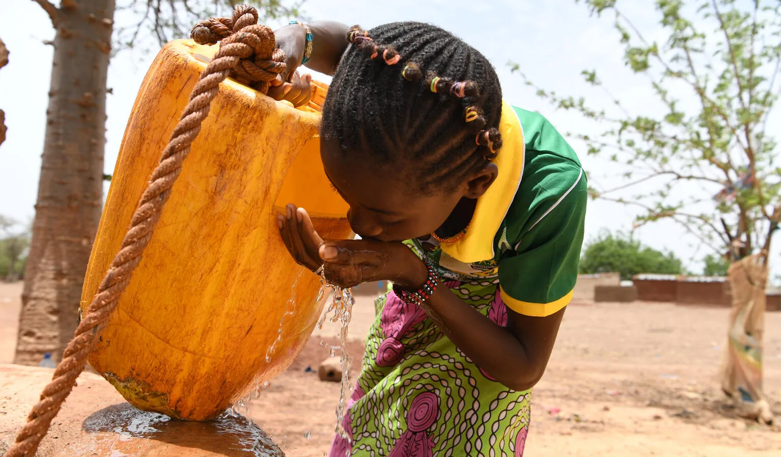 Children gathering water in the village of Naaba Guegma, in the Northern region of Burkina Faso.