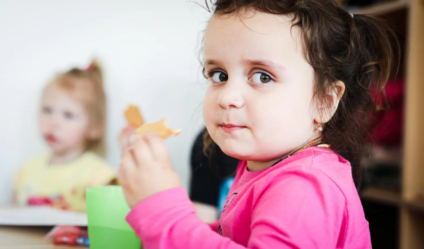 A child enjoys their lunch in school cafeteria 