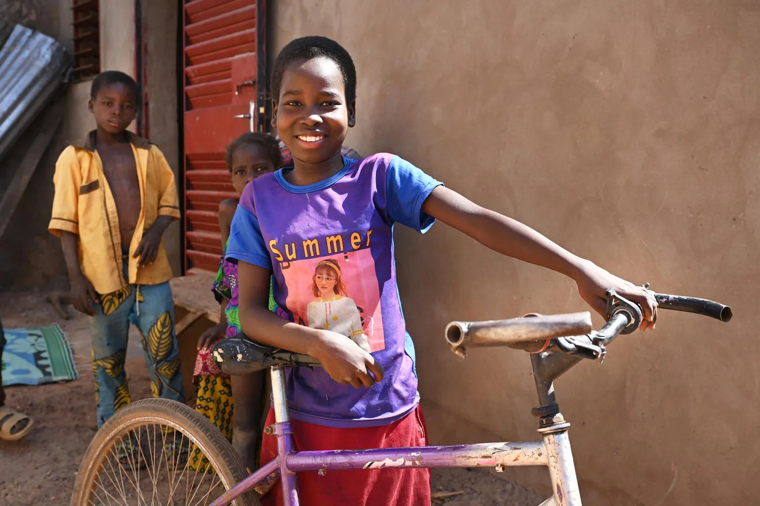 Awa Sobre, a 12 year old girl is very happy with her bicycle, in Dedougou, in the west of Burkina Faso.