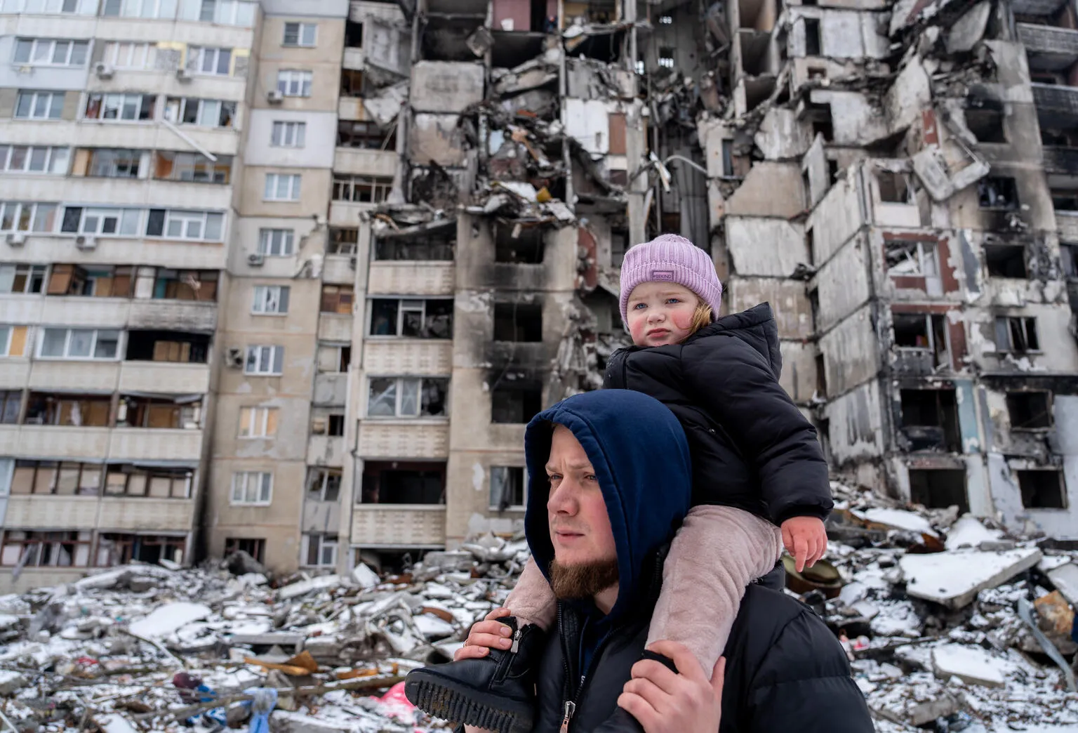 Oleksandr is on a walk in the courtyard with his two-year-old daughter Michelle in Saltivka, Ukraine.