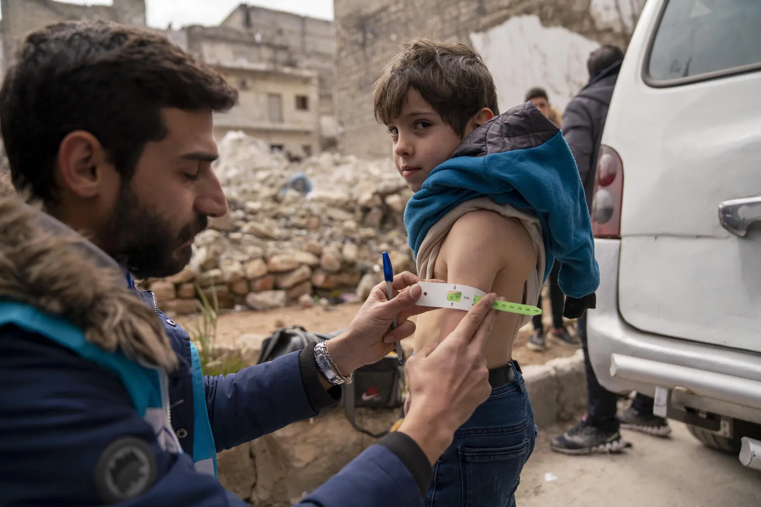 On 10 February 2023, Ayman, 5, is screened for malnutrition by a UNICEF-supported mobile health team worker.
