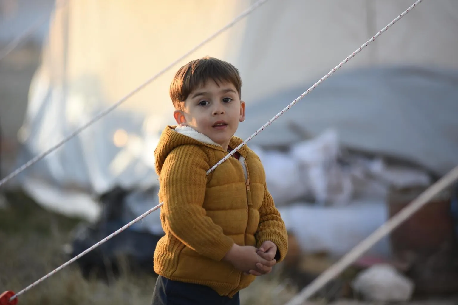 A boy at the temporary shelter set up for the survivors of the 7.7 magnitude earthquake in Kahramanmaraş, Türkiye.