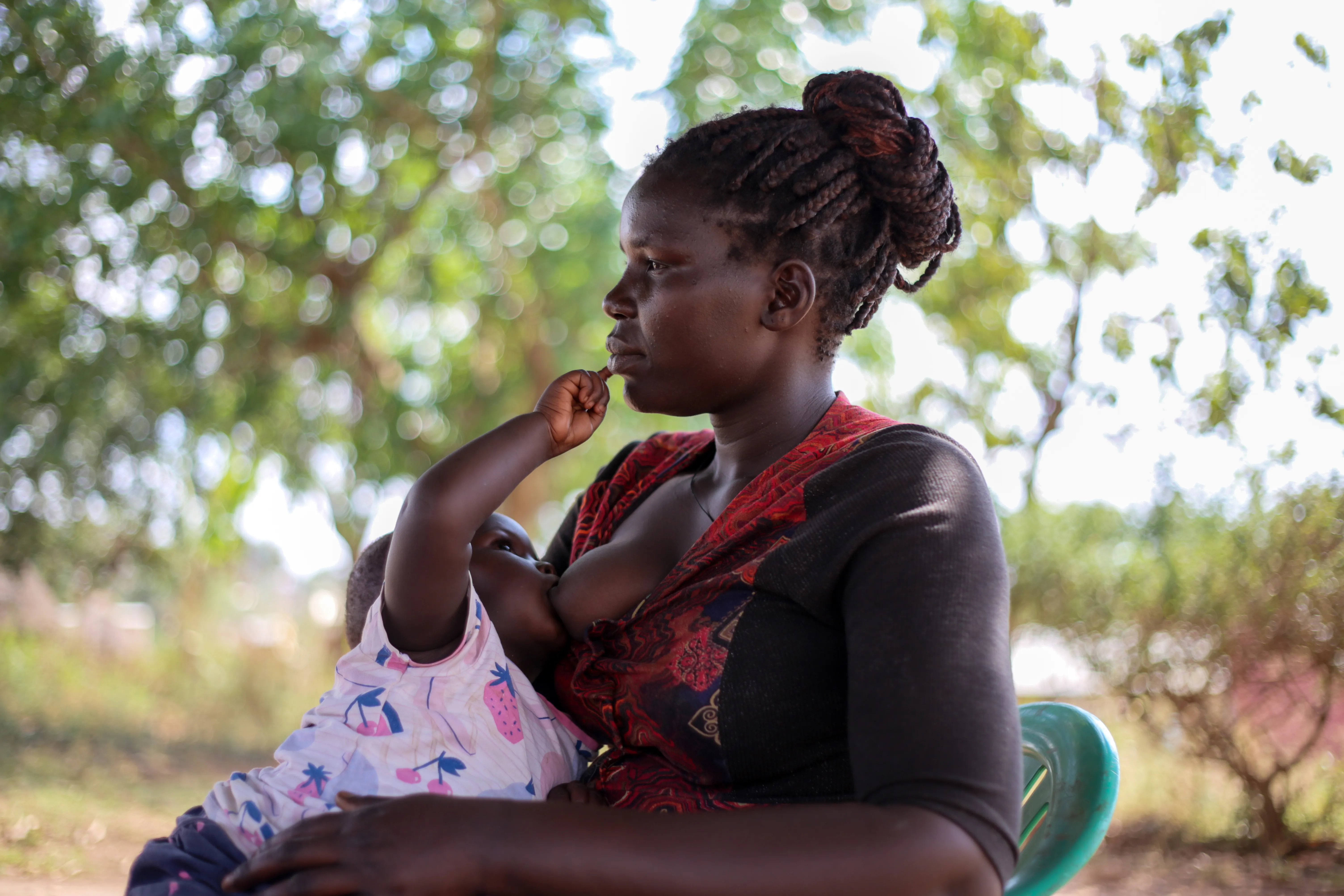 Amal Esther, a Care Group Volunteer from Cluster K, Panyadoli Refugee Settlement in Kiryandongo District breastfeeds her baby Anena on 3 March, 2023.