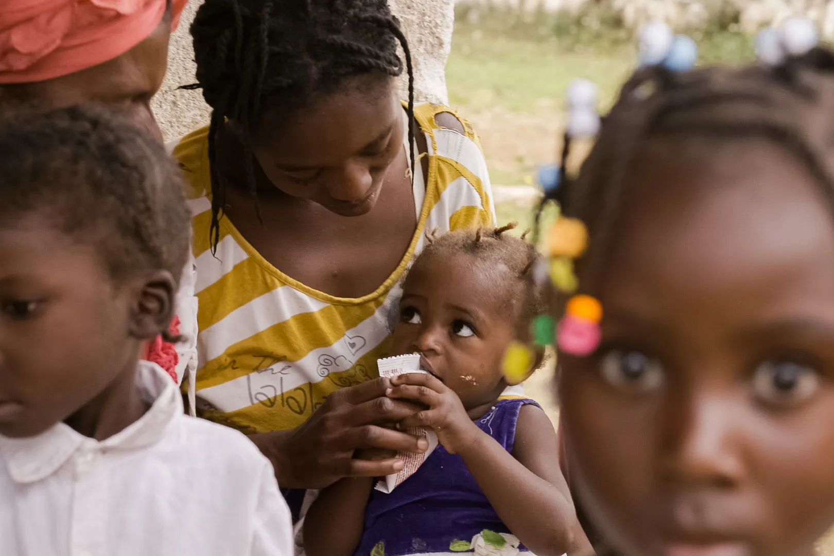 Child eating peanut plan at a health center for nutrition. Mare Briole, departement South-East, Haiti, September 2019.