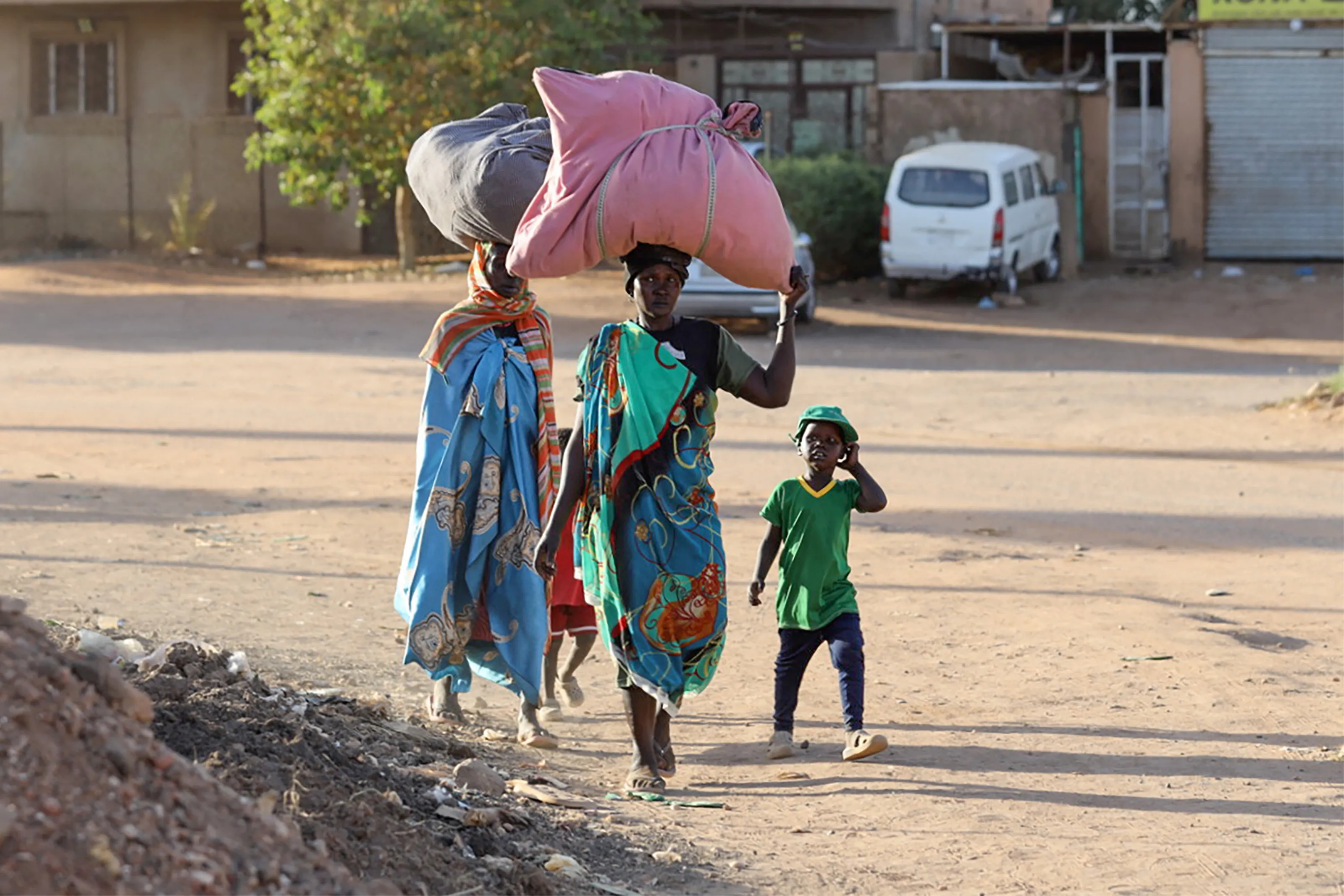 On 19 April 2023, people flee their neighbourhoods amid fighting between the army and paramilitaries in Khartoum, Sudan.