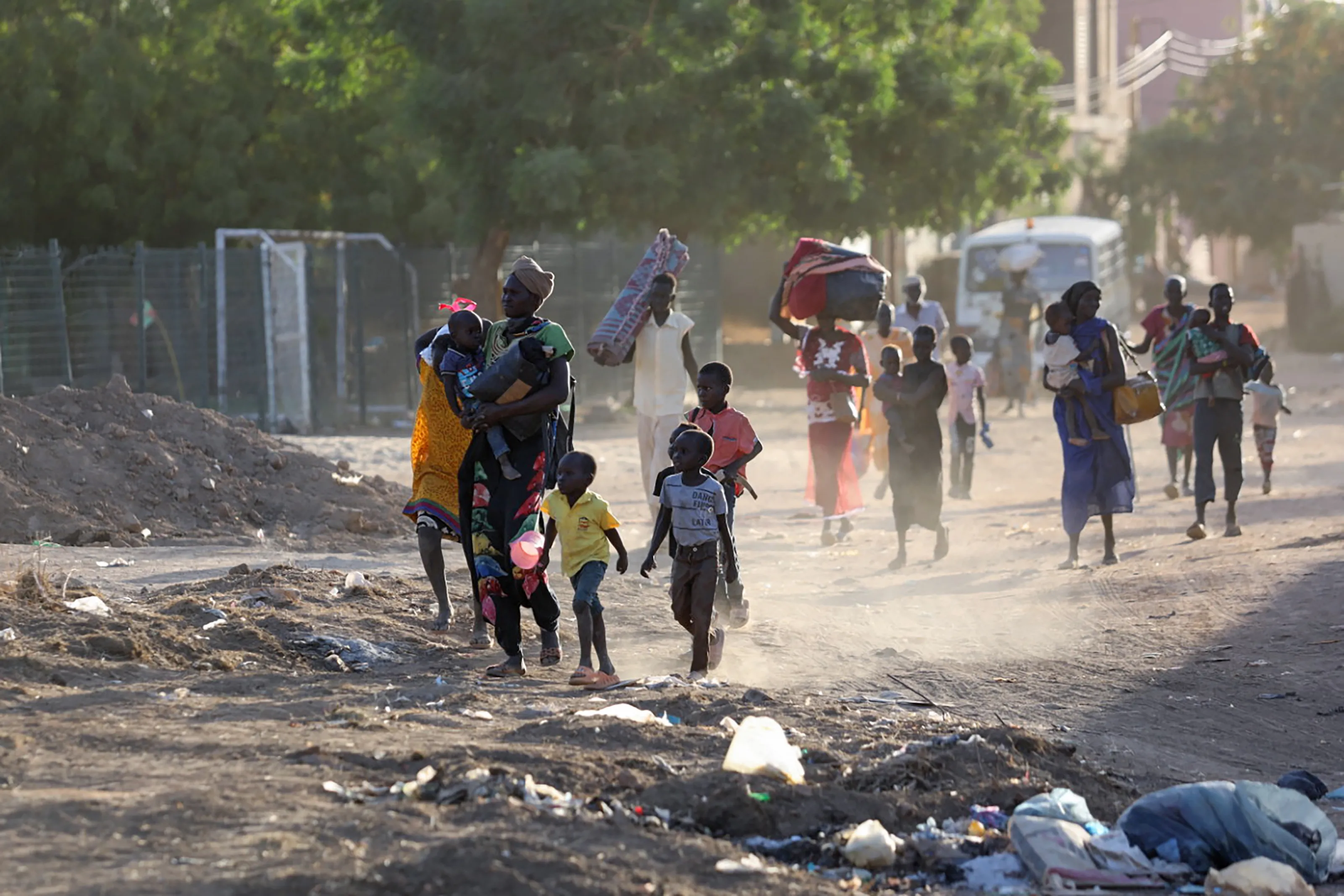 On 19 April 2023, people flee their neighbourhoods amid fighting between the army and paramilitaries in Khartoum, Sudan.