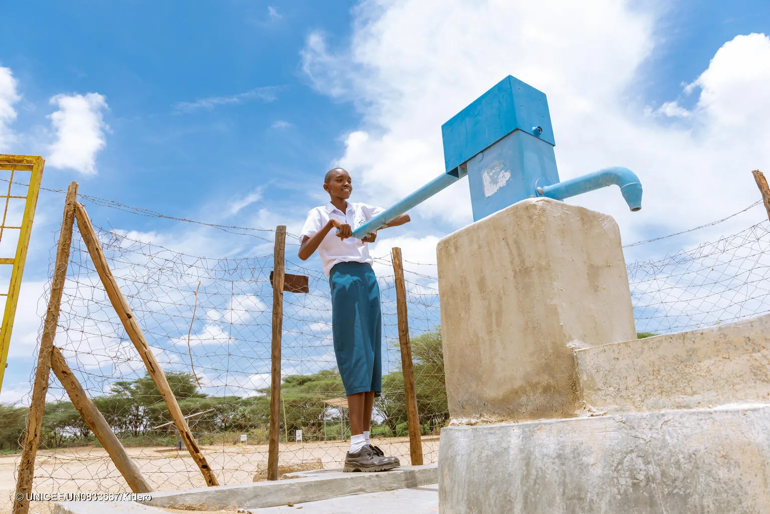 In Turkana, Kenya a young girl uses a handpump for water