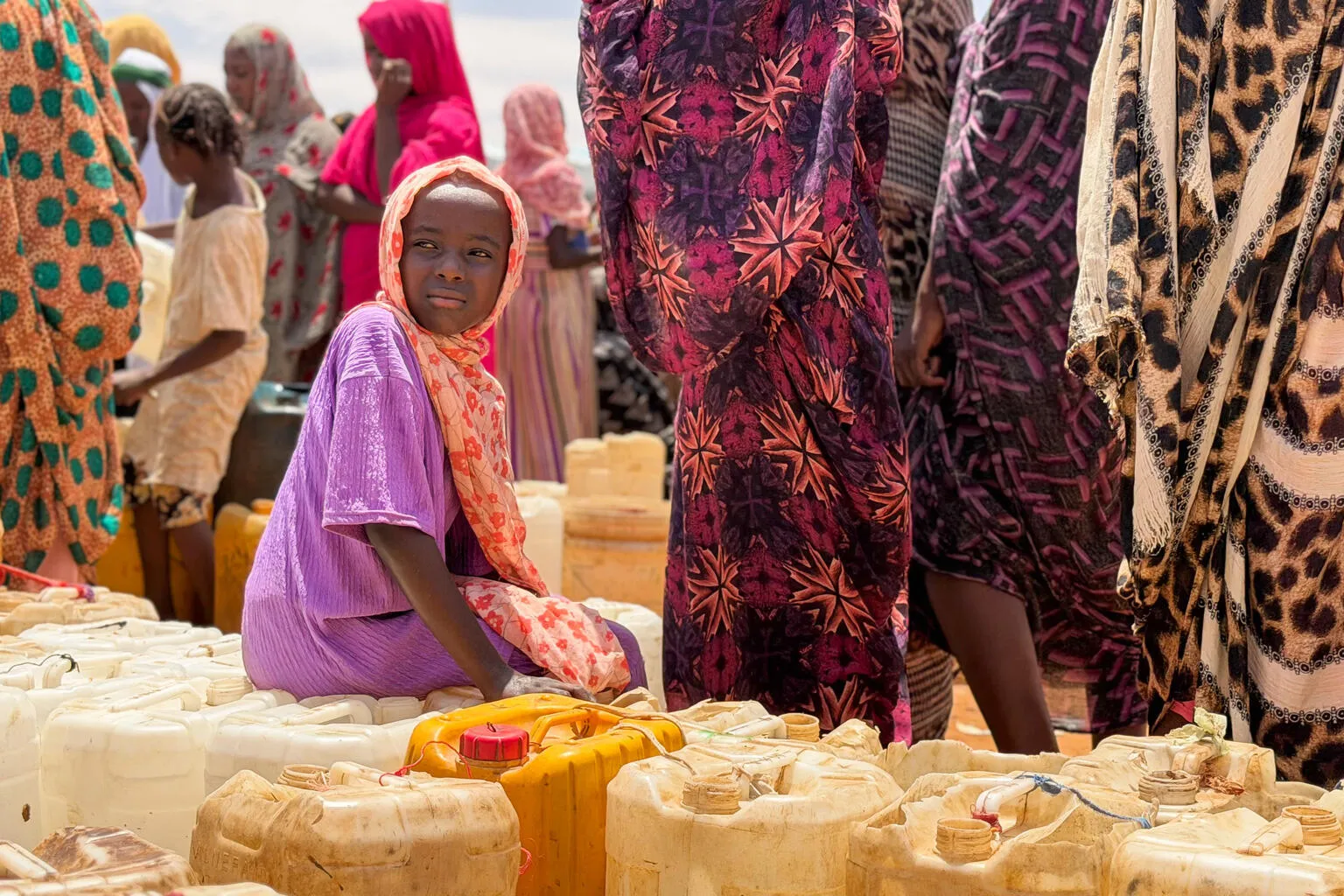 Children and women queue for water in Al Obeid, Sudan. 