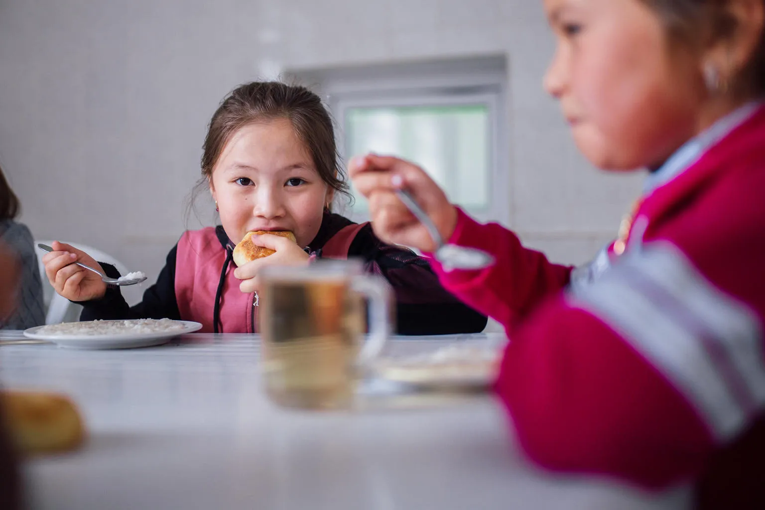 A girl eats a healthy school lunch.