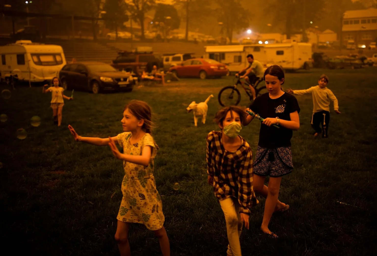 Children play at the showgrounds in the southern New South Wales town of Bega where they are camping after being evacuated from nearby sites affected by bushfires.