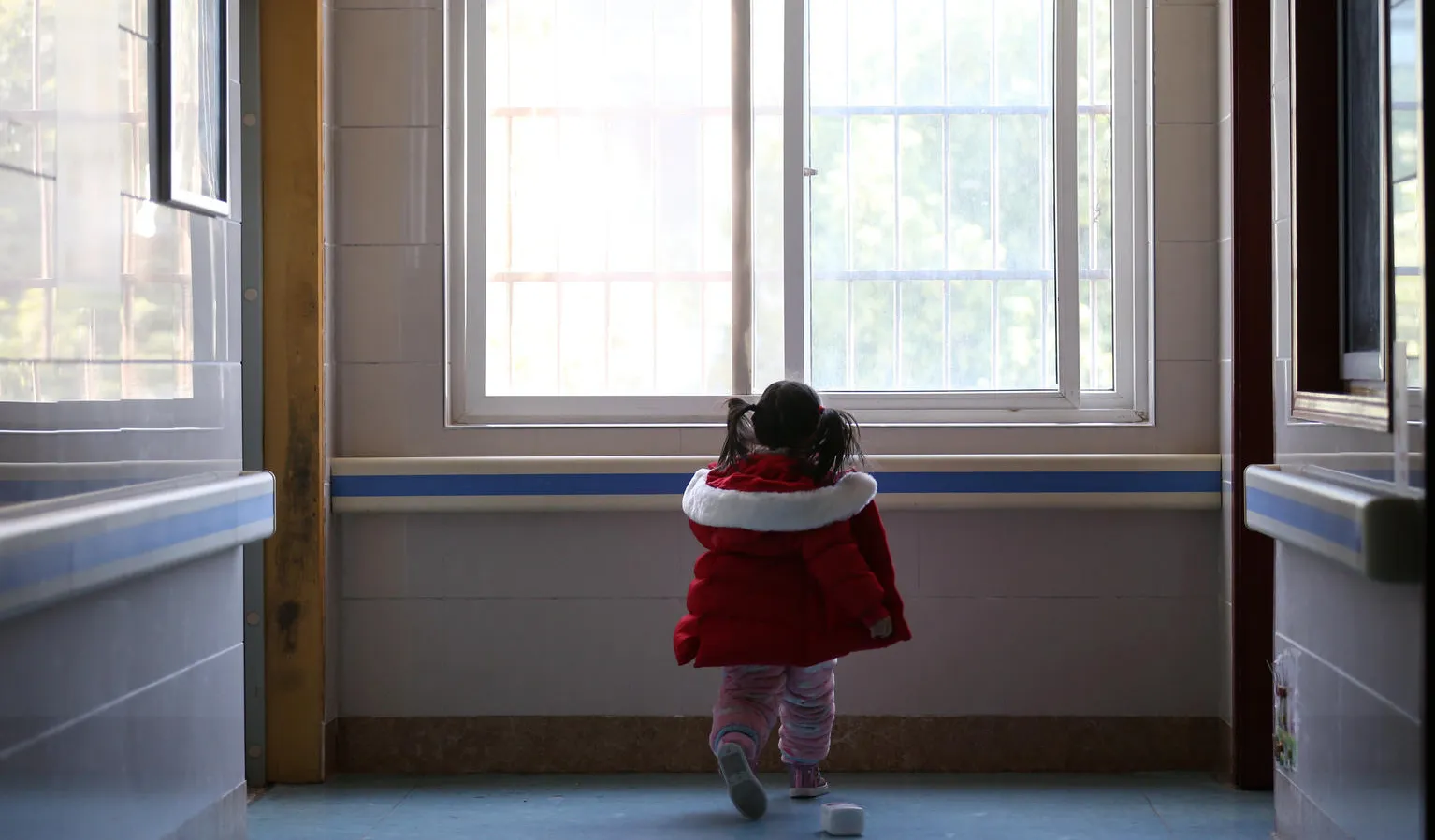 Five-year-old Yuanyuan walks the corridor of a hospital affiliated to the Wuhan University of Science and Technology in China.