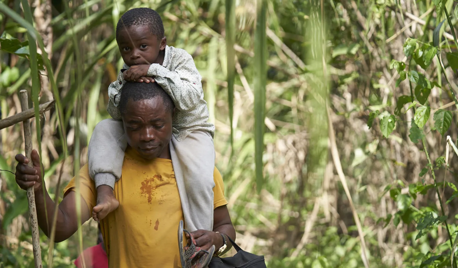 On 5 February 2020, Romeu Mauricio and his son, Jetfro, 3, cross through the Darien Gap jungle dividing Colombia and Panama.