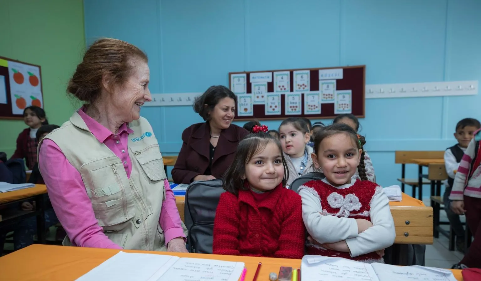 ED Fore sits with children in a classroom in Turkey.
