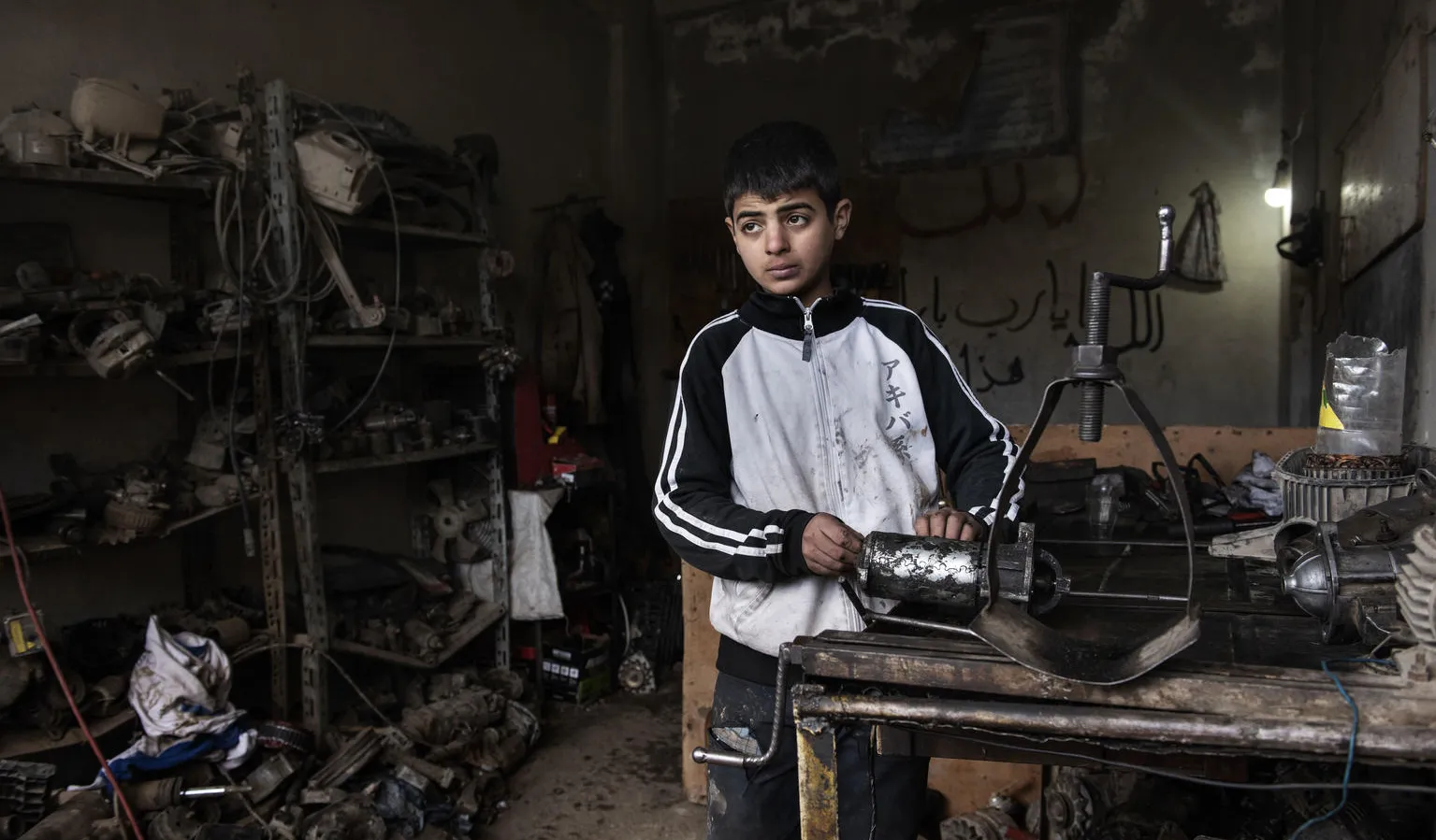 13 year old Ibrahim works in a mechanics shop to help support his family in Syria.