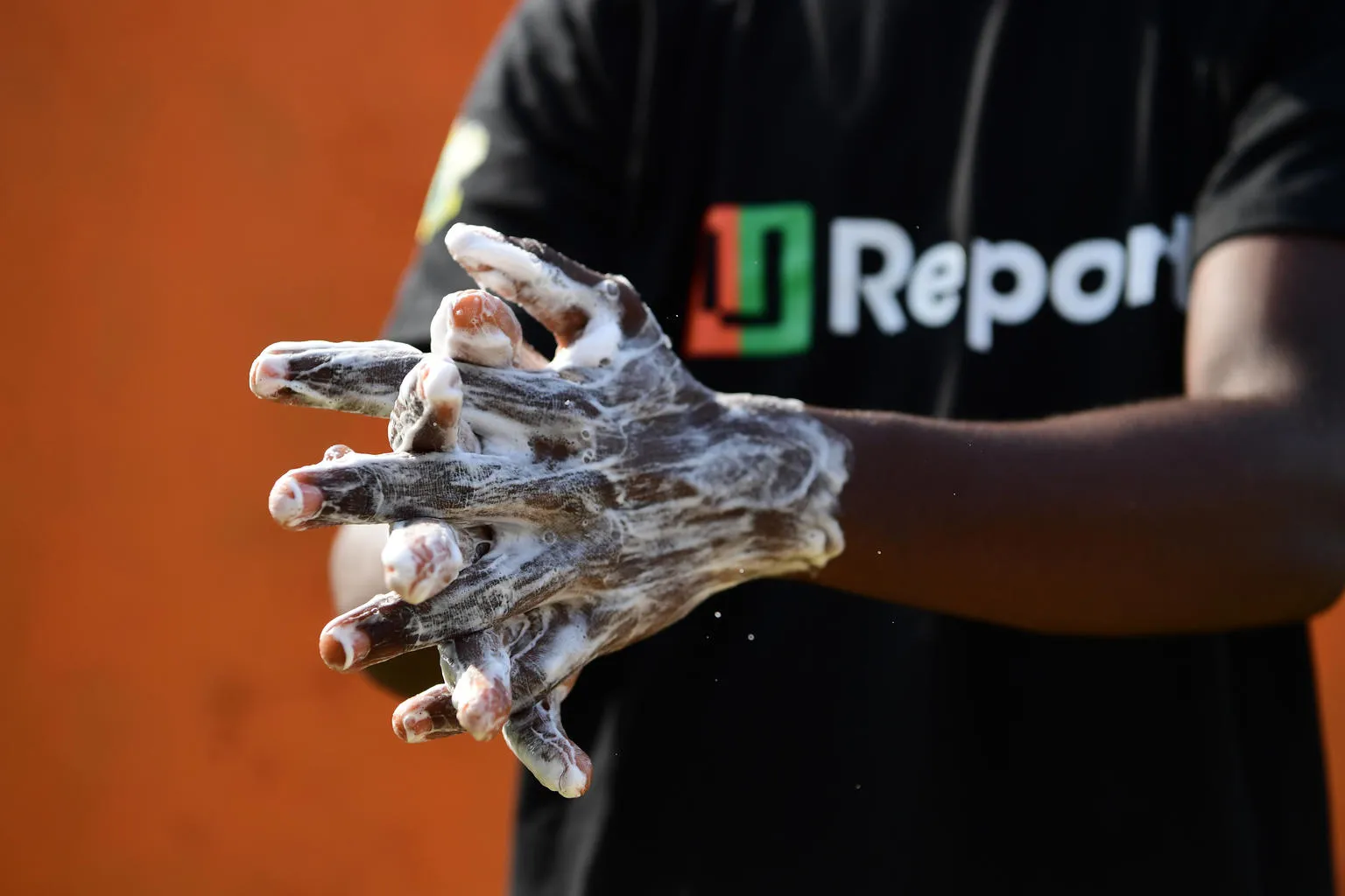 A U-Reporter demonstrates proper handwashing techniques in Cote D'Ivoire.