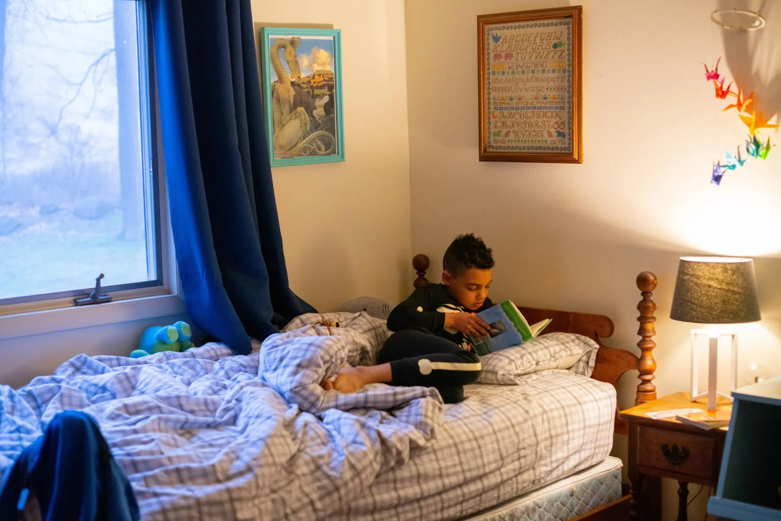 Luka reads in bed before starting his day.