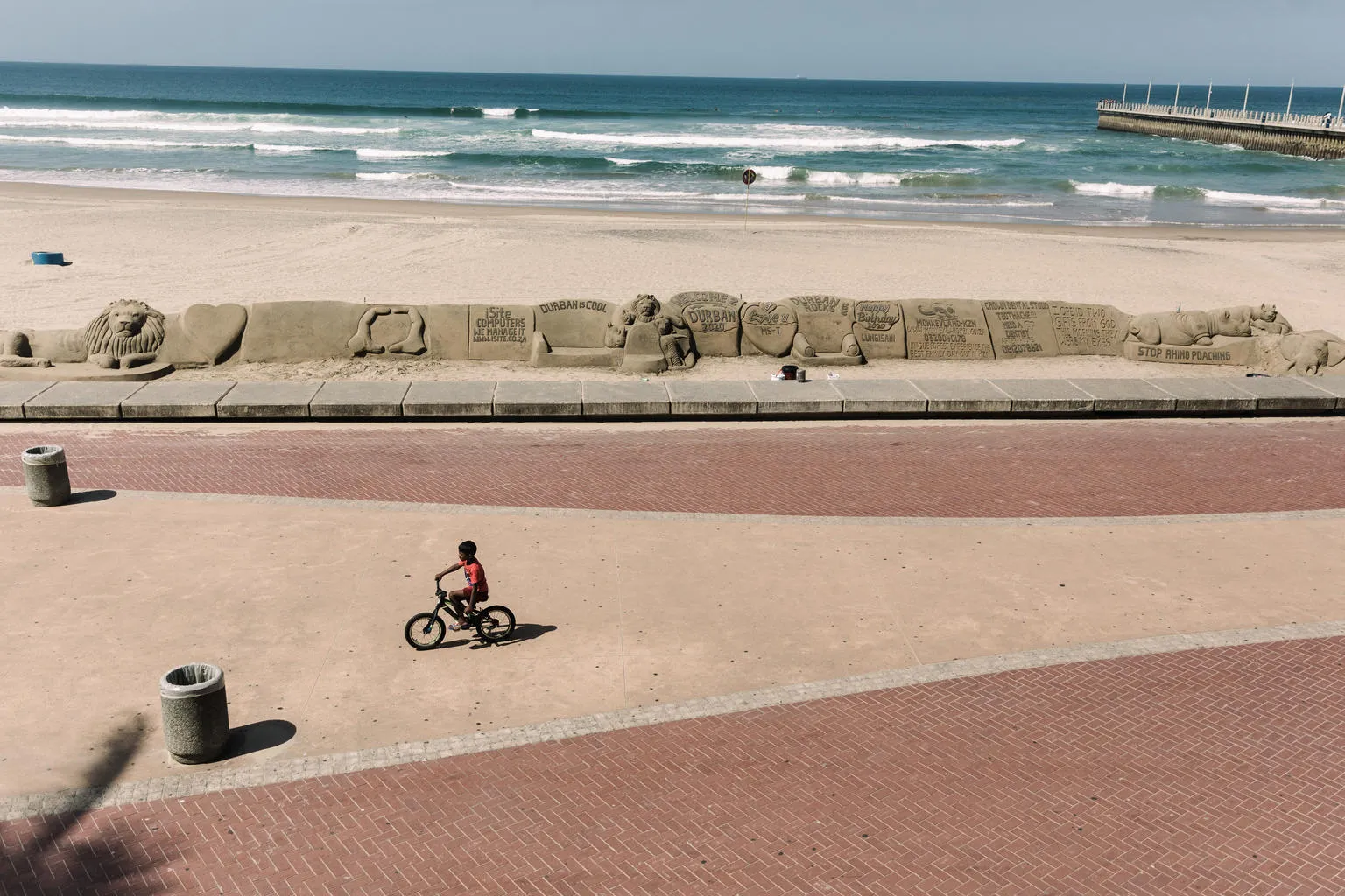 A lone cyclist rides along a beach in Durban.