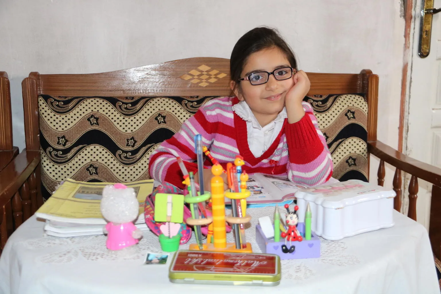Masa, age 9, studies at her home in Syria.