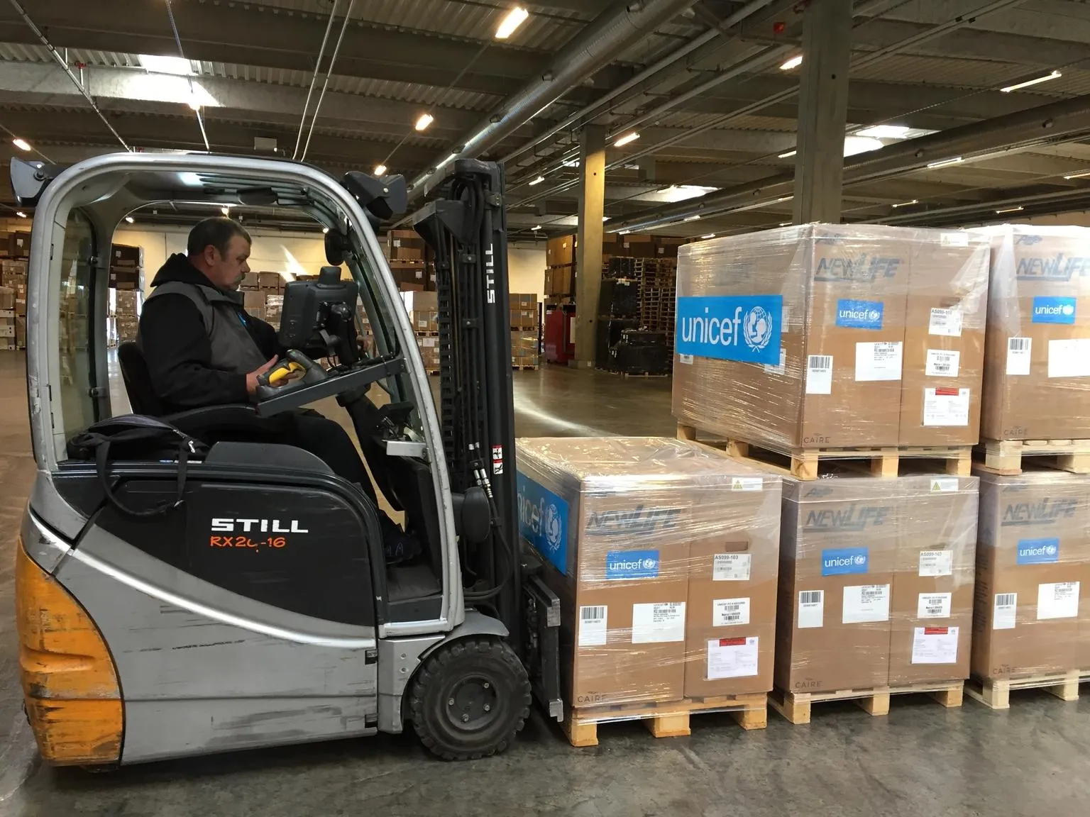A UNICEF worker prepares to move supplies to be shipped to the DRC.