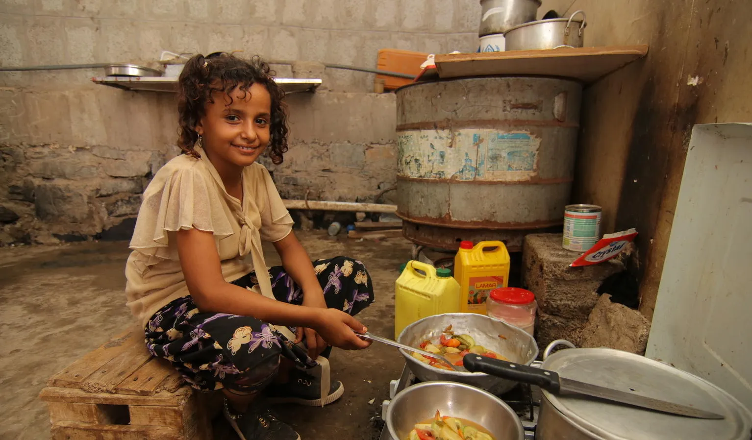 Muna cooks at home.