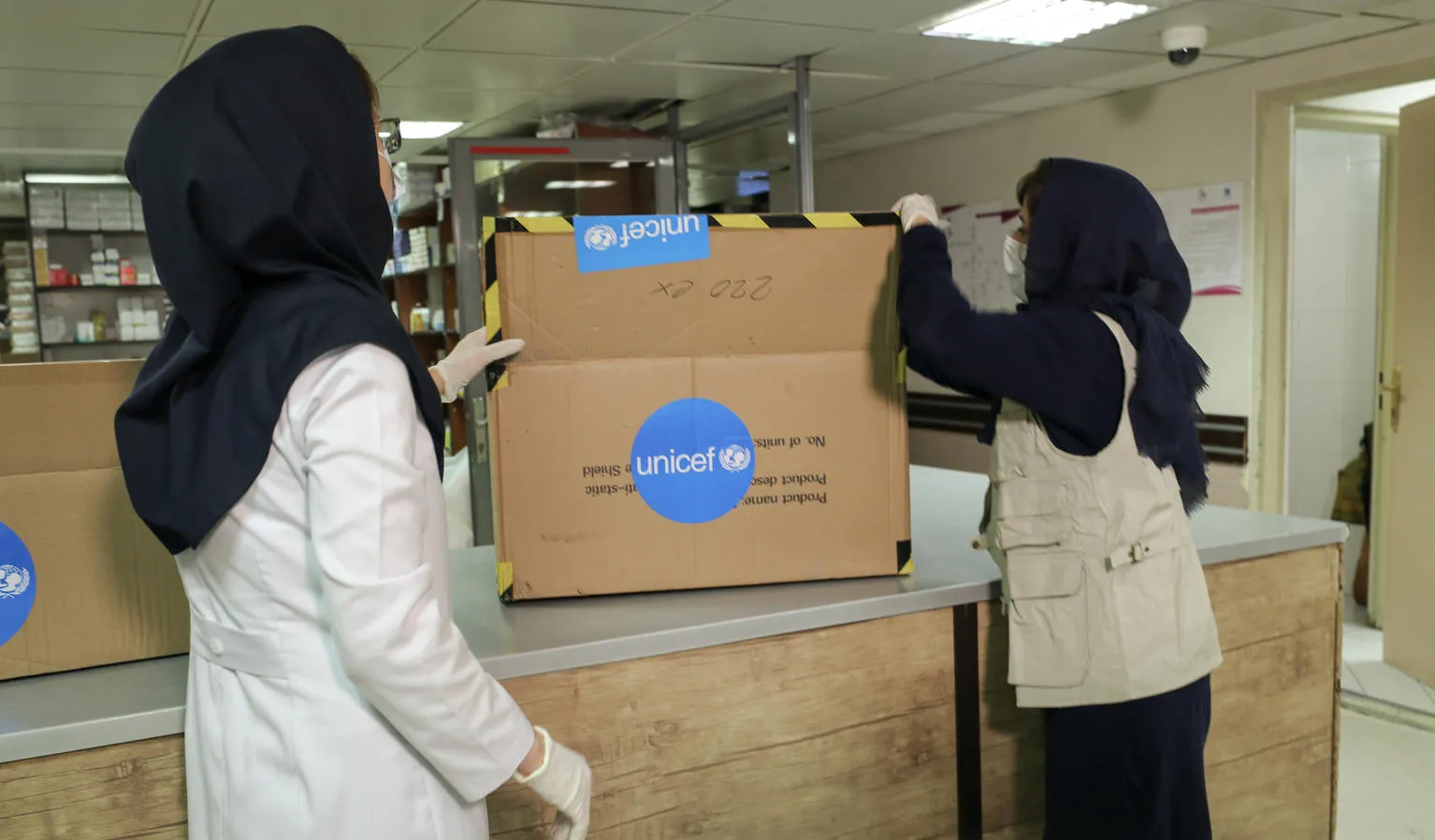 Health workers inspect a delivery of supplies.