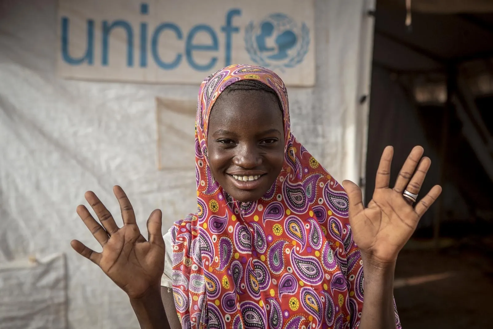A youth advocate shows off her clean hands.