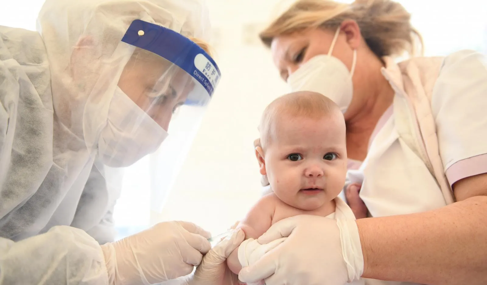 A baby receives a vaccination injection.