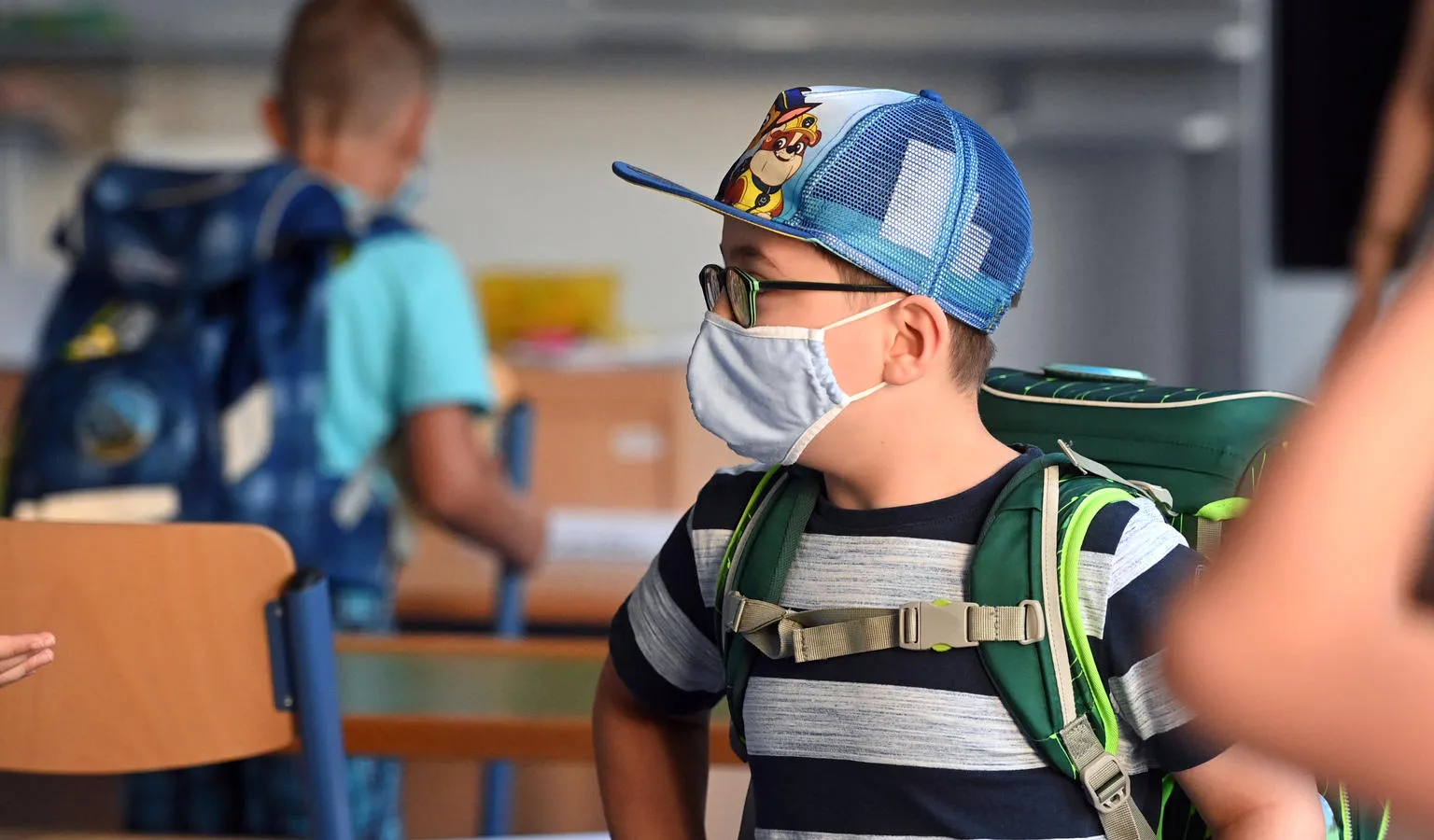 A student with a face mask stands in a classroom at the Petri primary school in Dortmund, western Germany.