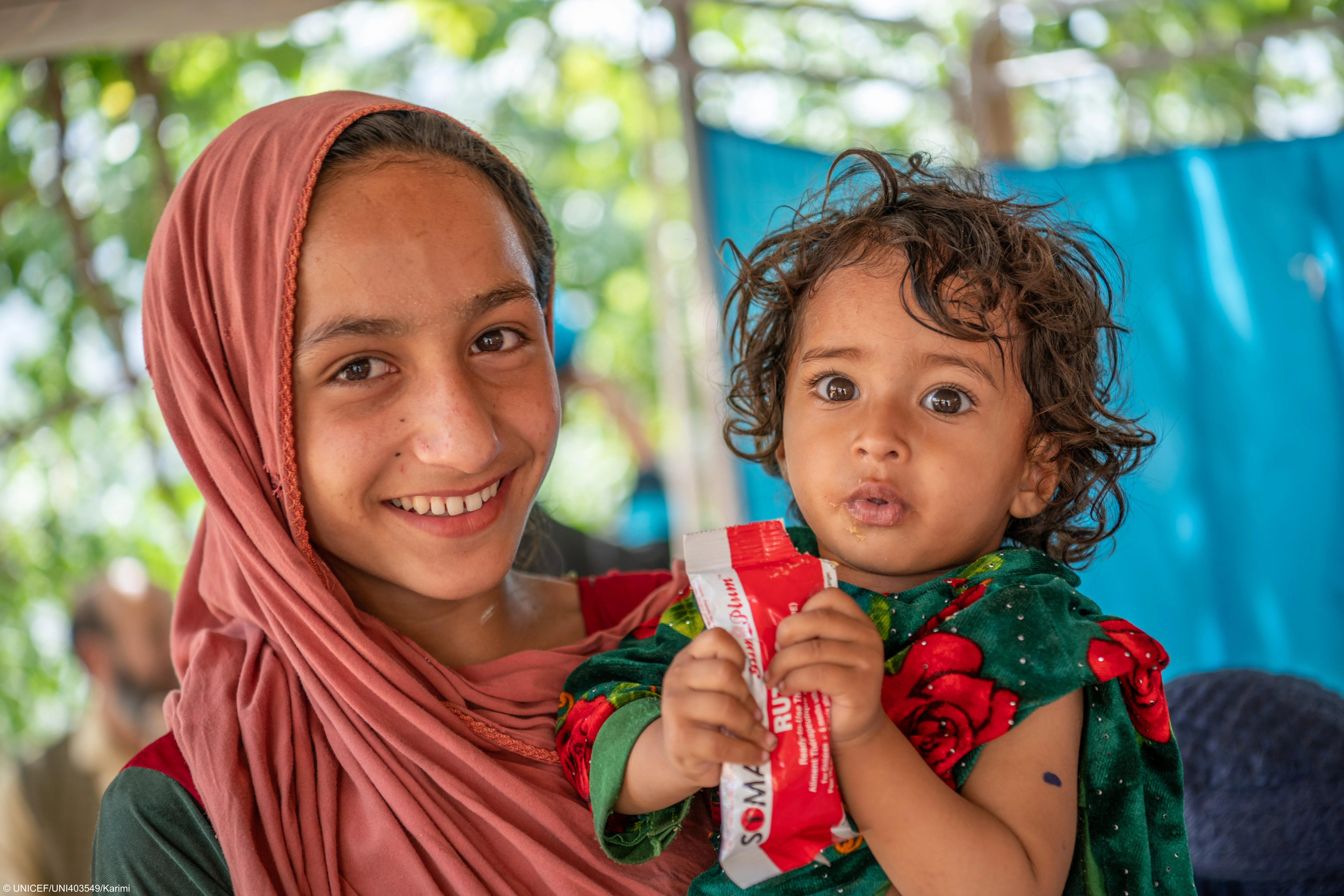 A child named Zarmina receives RUTF at UNICEF-supported mobile health and nutrition in Afghanistan. 
