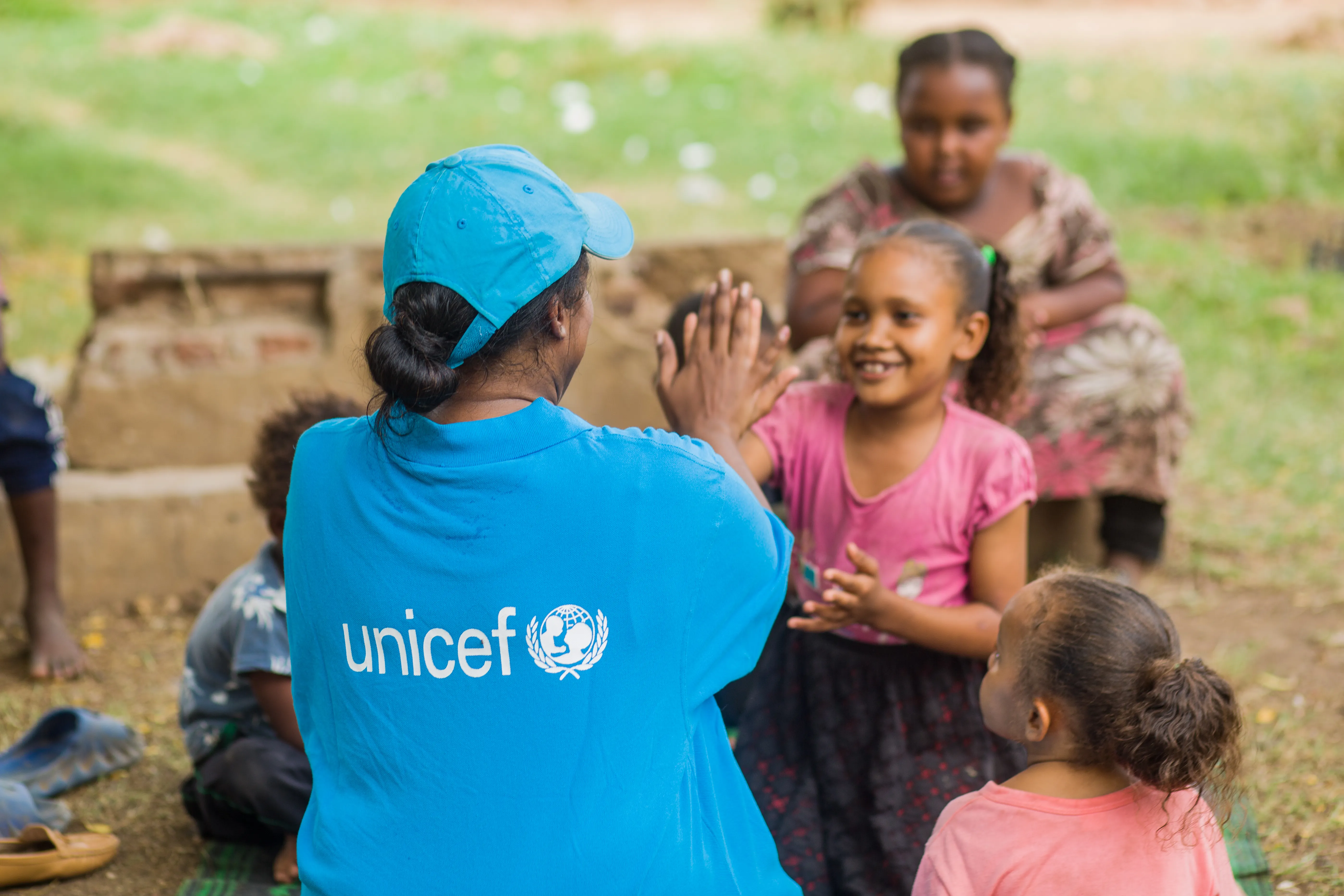 A UNICEF Staff member plays with a child in Sudan. 