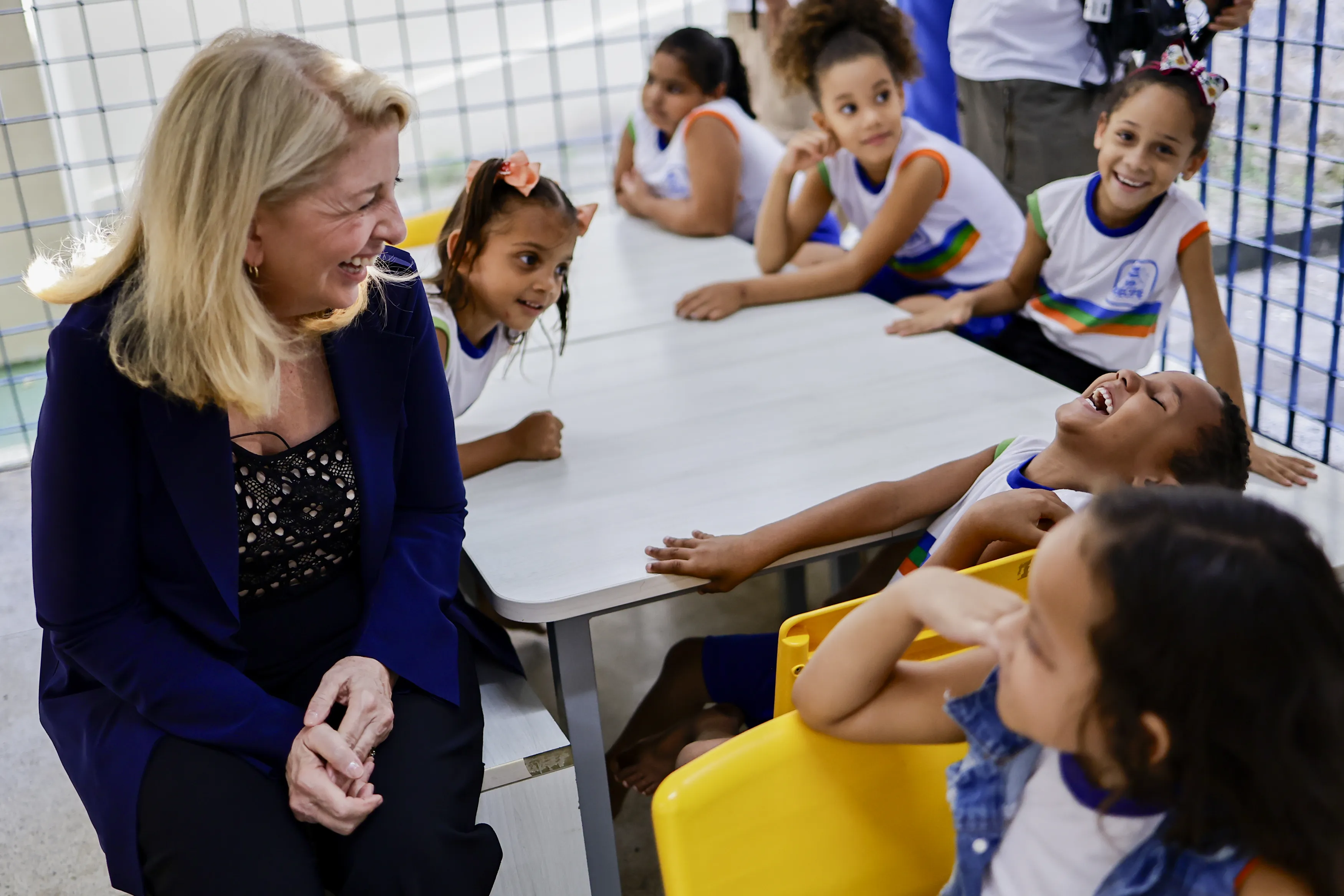 On 30 August 2023 in Brazil, UNICEF Executive Director Catherine Russell shares a good laugh with a student while visiting the CEMEI 8 de Março school in the Ibura neighbourhood of Recife.