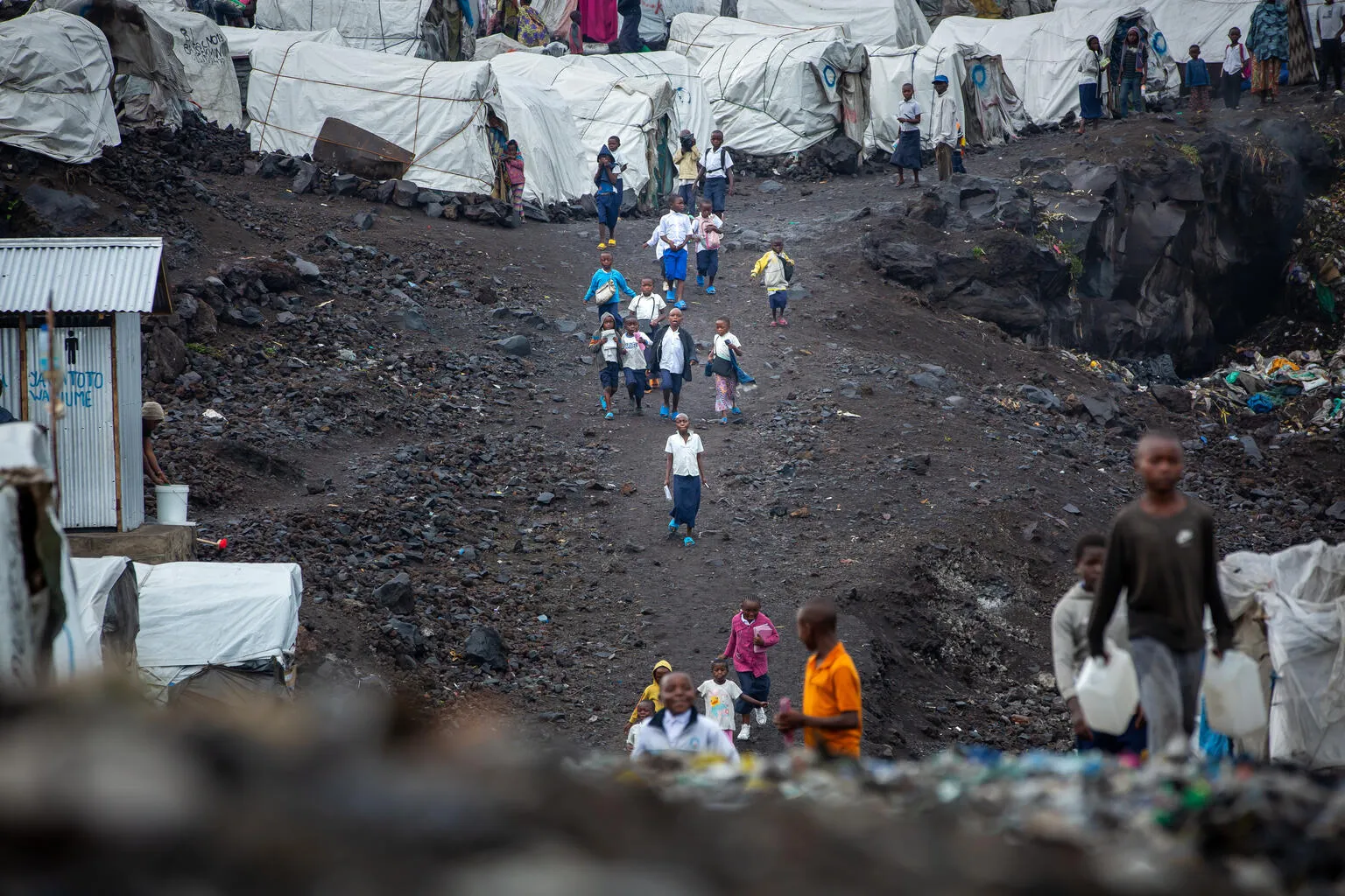Displaced children on their way to school at the Lushagala IDP site in North Kivu province, DR Congo on 11 September 2023. UNICEF and its partners have set up temporary learning spaces in the site to allow displaced children to continue their learning.