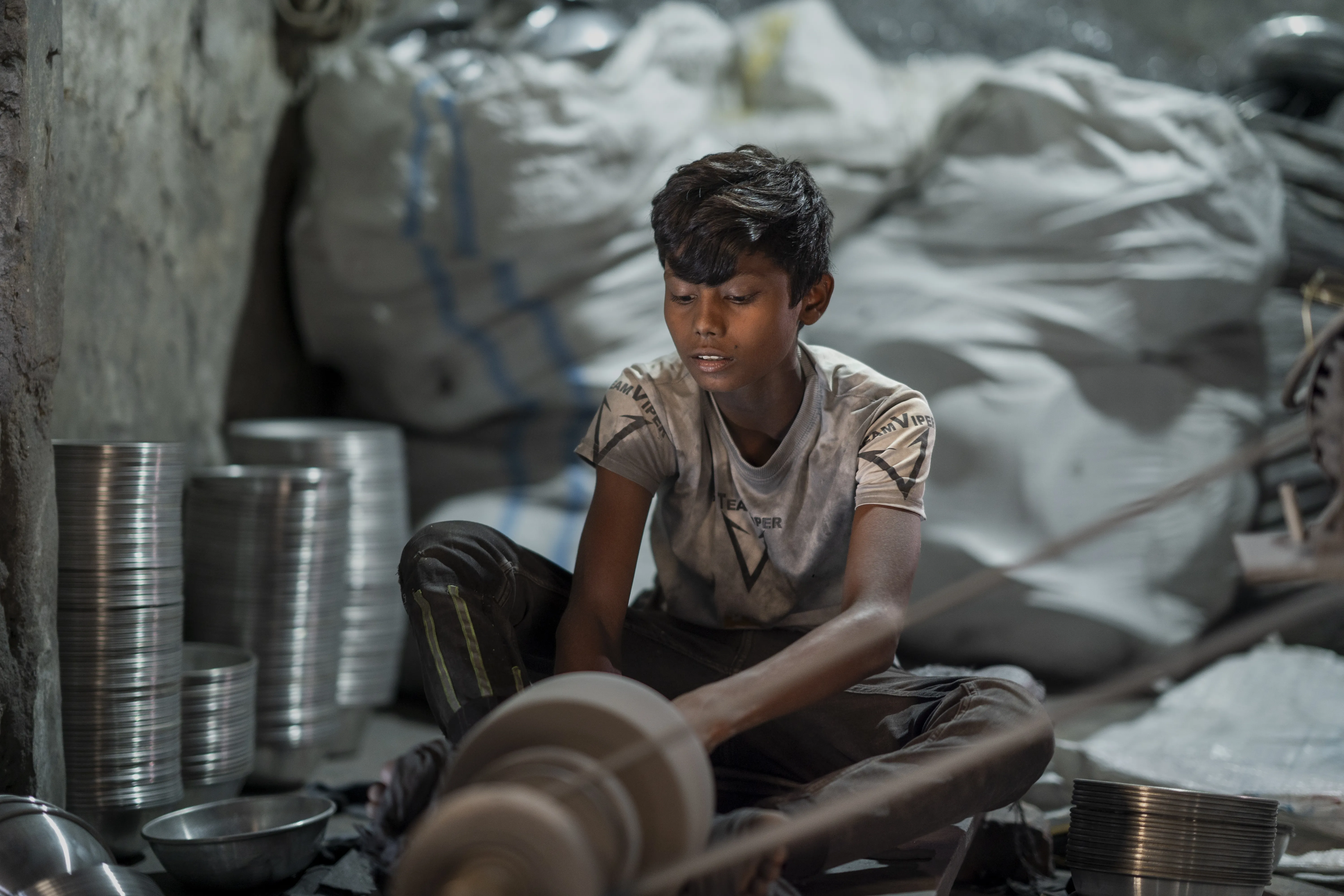A child works in small silver polishing factory in Bangladesh