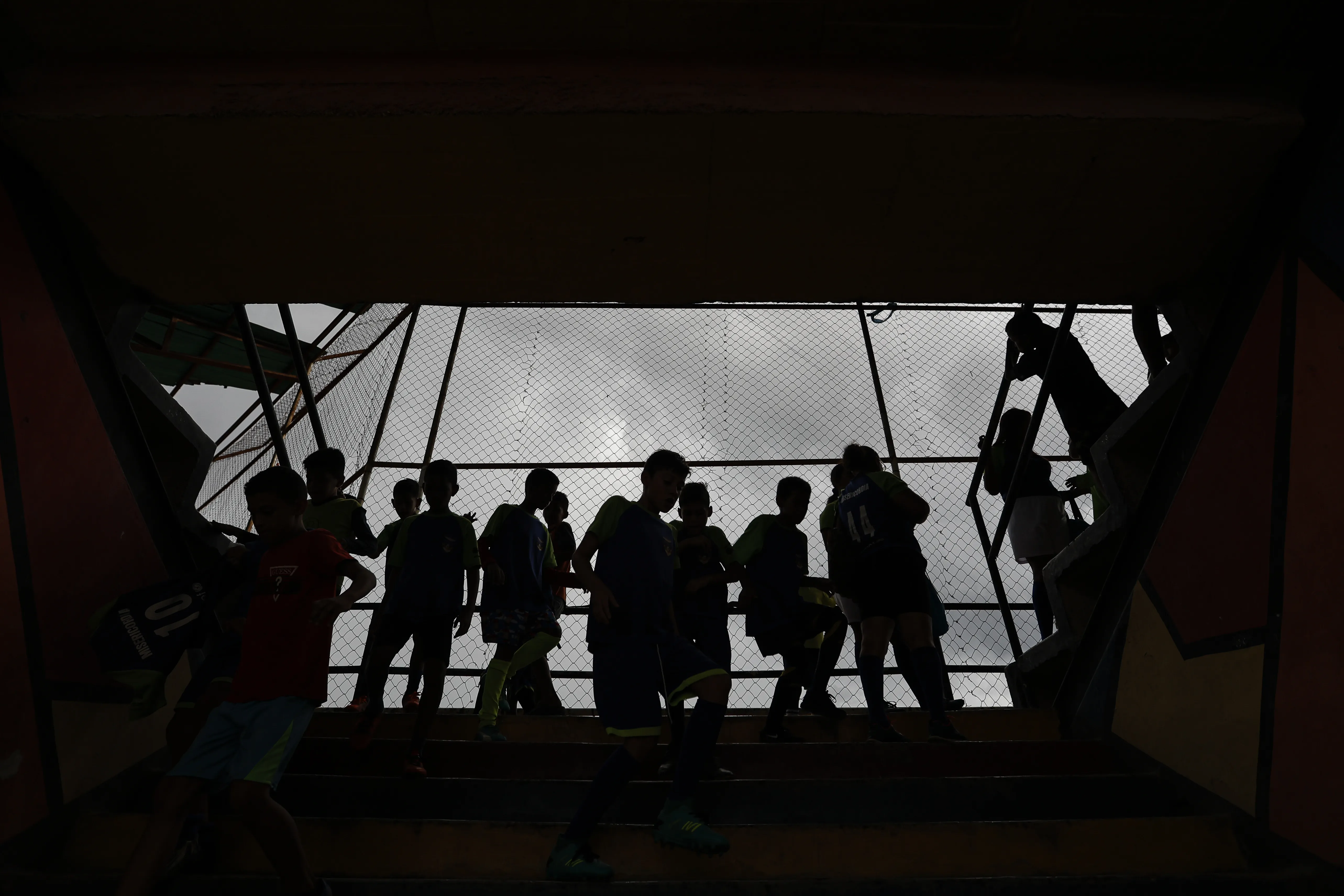 Silhouette of children standing on a balcony 