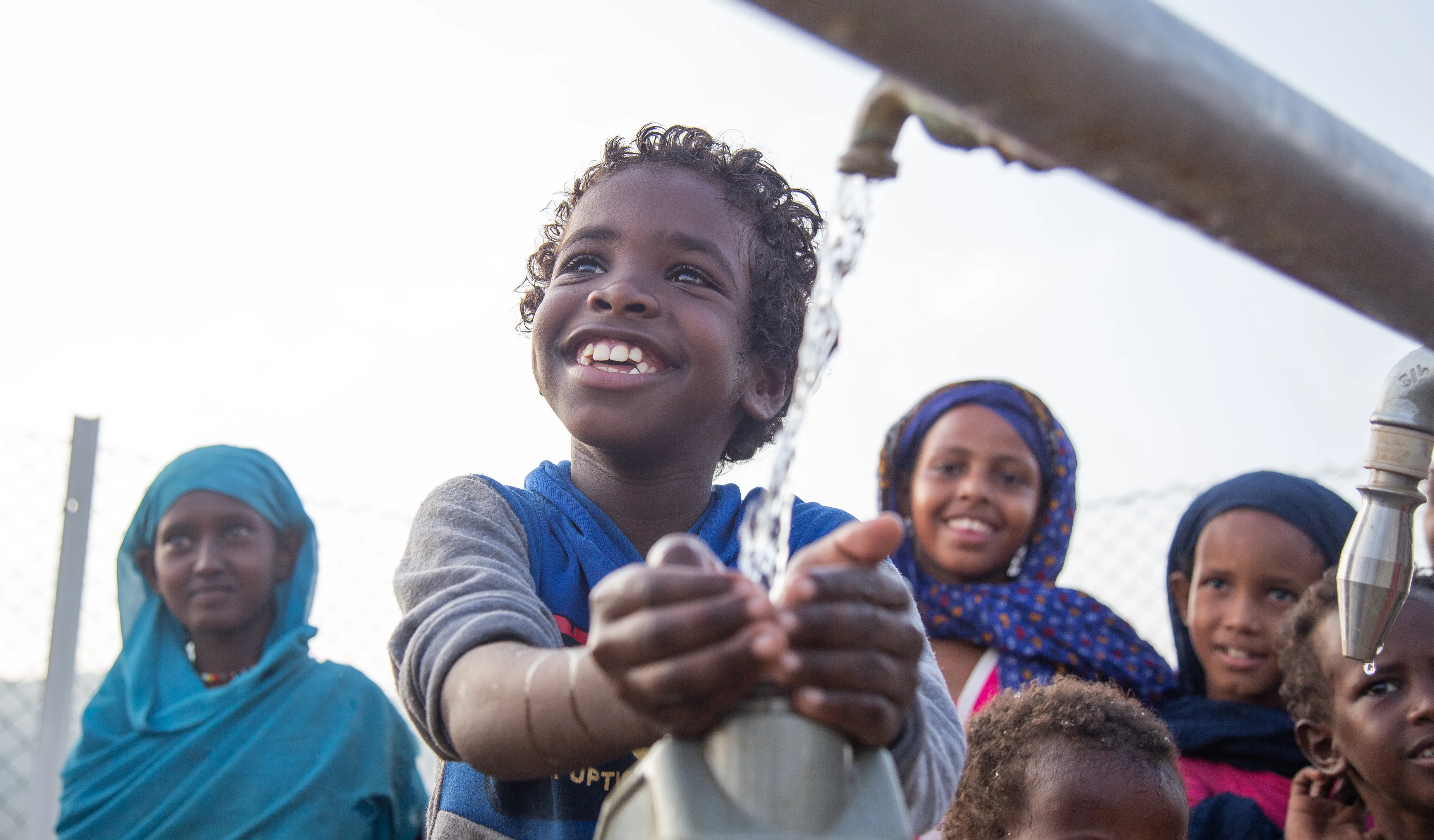 Children collect safe water from a new water station in the village of Gelhanty, Sudan.