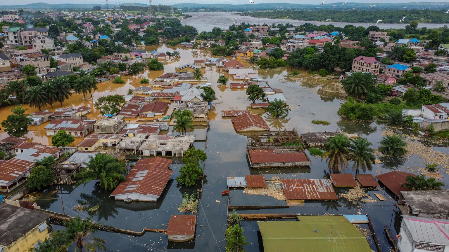 The image captures a Bird's eye-view of houses being flooded.