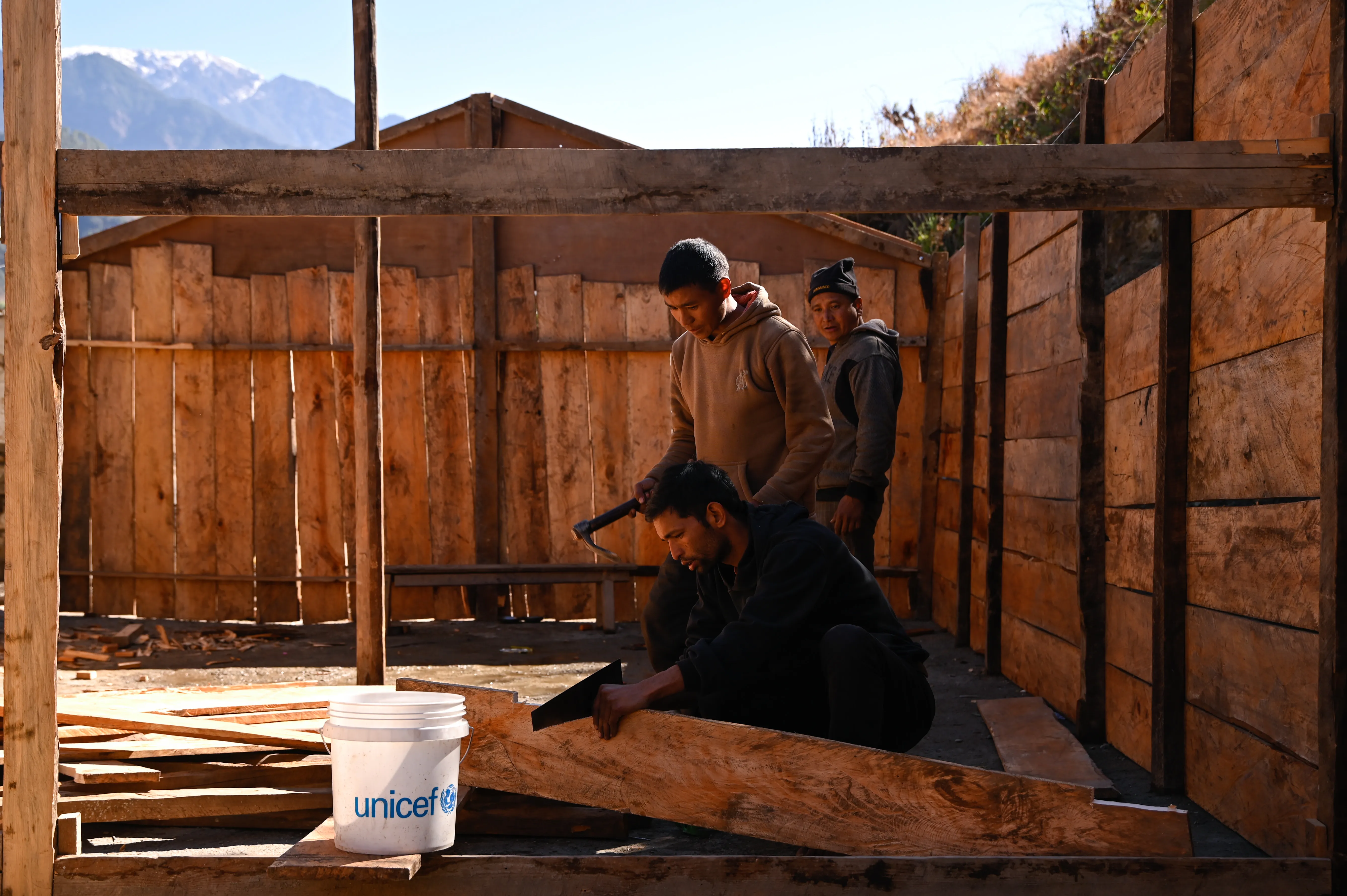 Deux hommes reconstruisent une école.