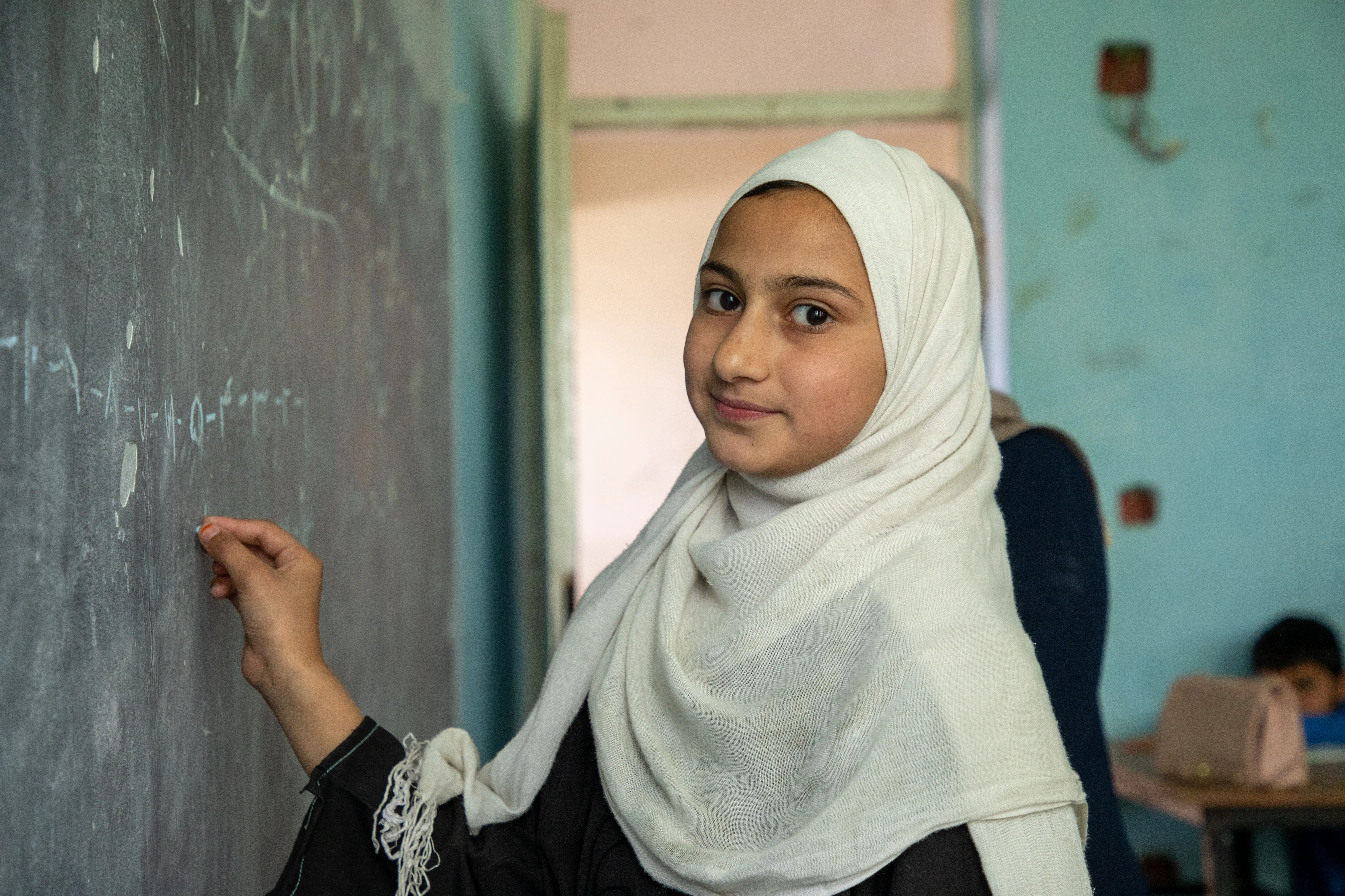 On 11 June 2024, primary school students in Kabul interact with other students and teachers.