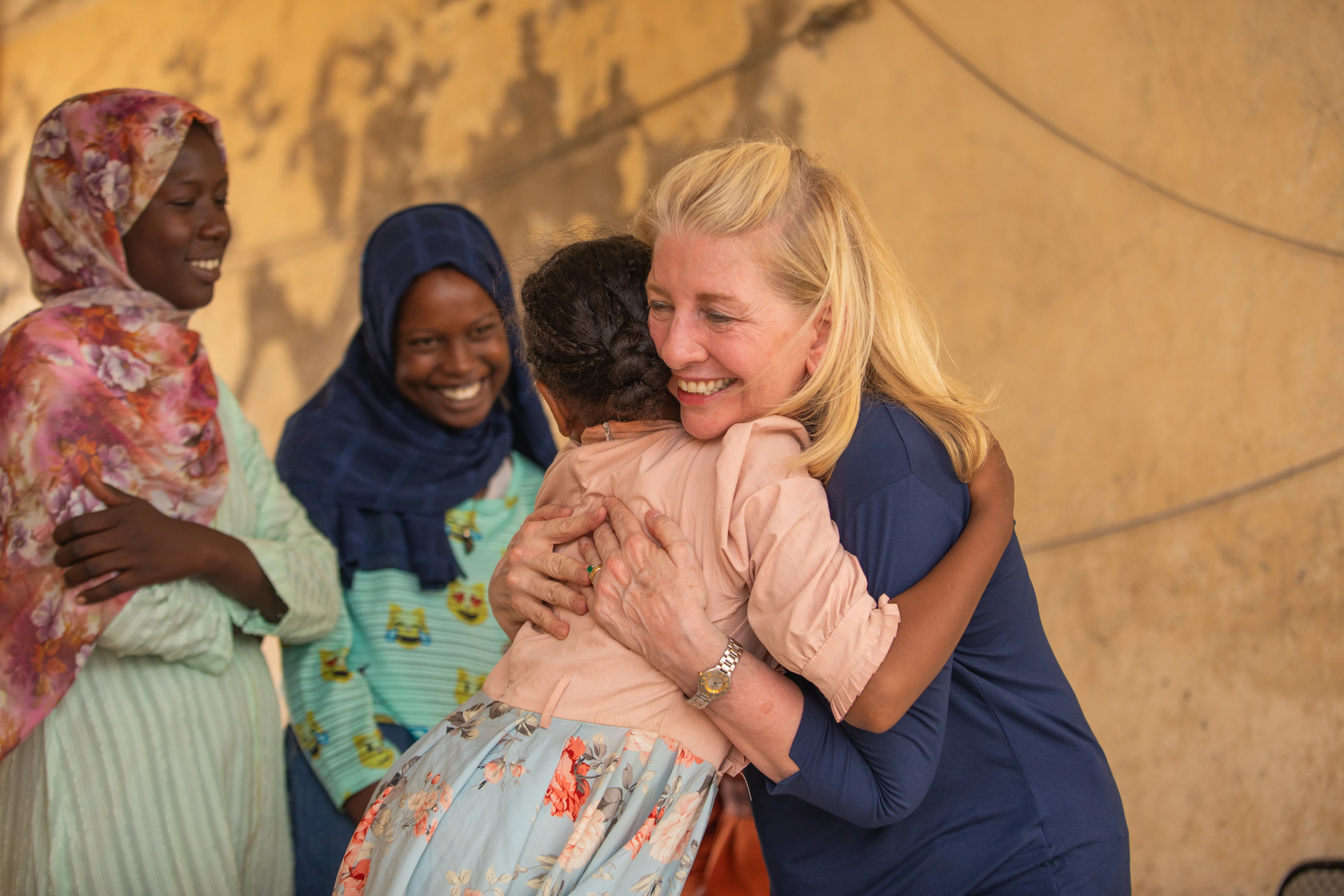 UNICEF Executive Director Catherine Russell hugs 11-year-old Yomna after meeting with her and other adolescent girls displaced by the war, at Abdullah Naj internally displaced people's gathering point in Port Sudan.