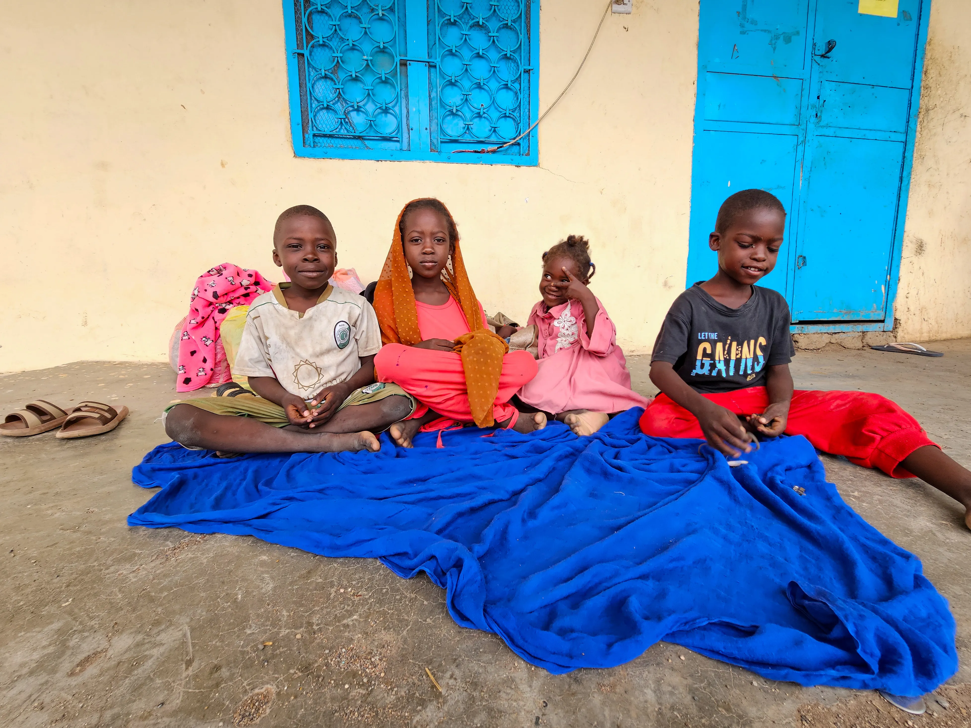On 1 July 2024, displaced children sit next to their luggage at a school in Gedaref after fleeing Sinja, Sennar state, following the recent clashes.