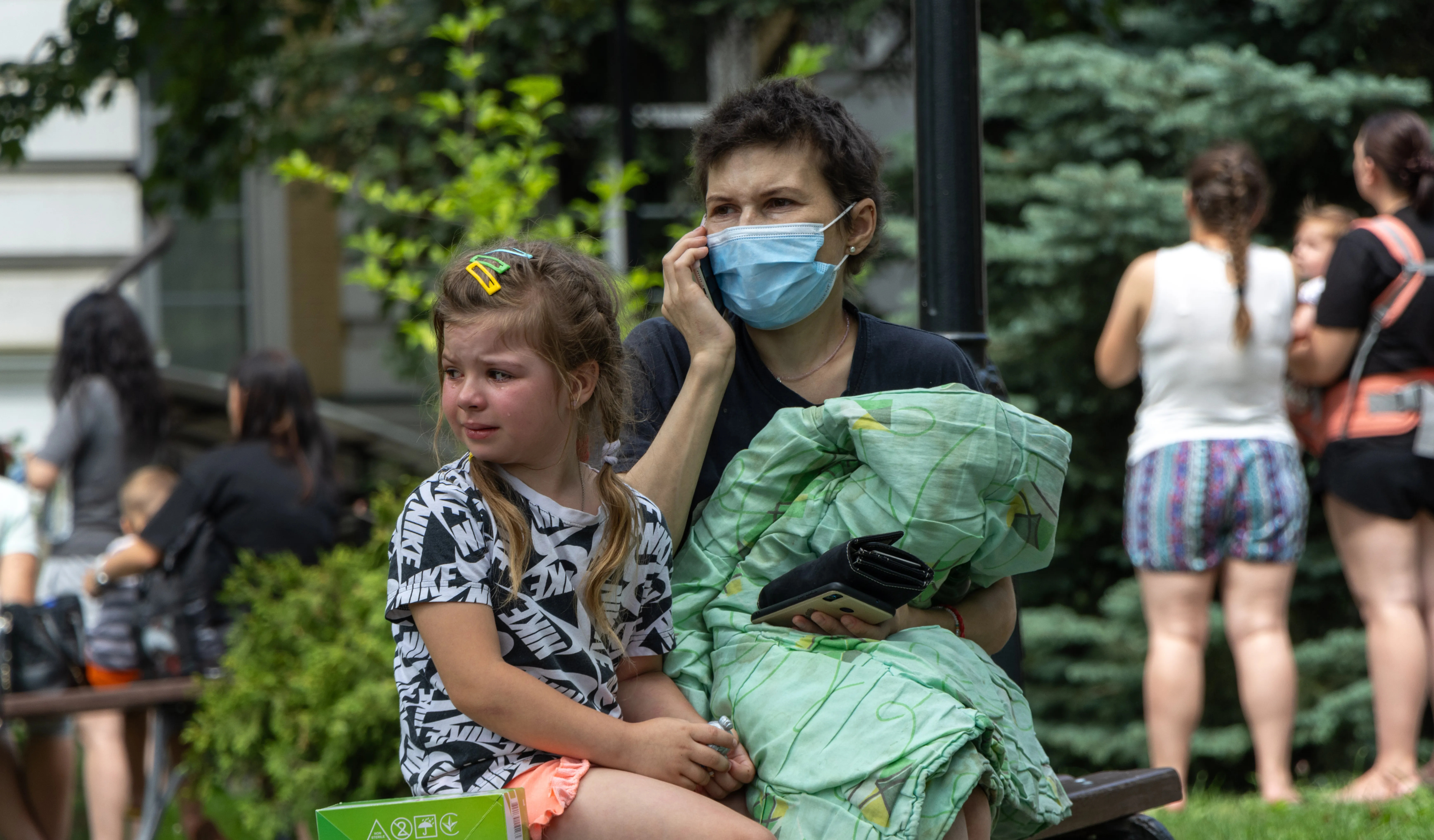 On 8 July 2024 in Kyiv, a child sits on a bench and cries as rescuers, hospital staff and volunteers clear rubble and search for people trapped under debris after an attack that hit Okhmatdyt hospital, Ukraine's largest children's medical centre.
